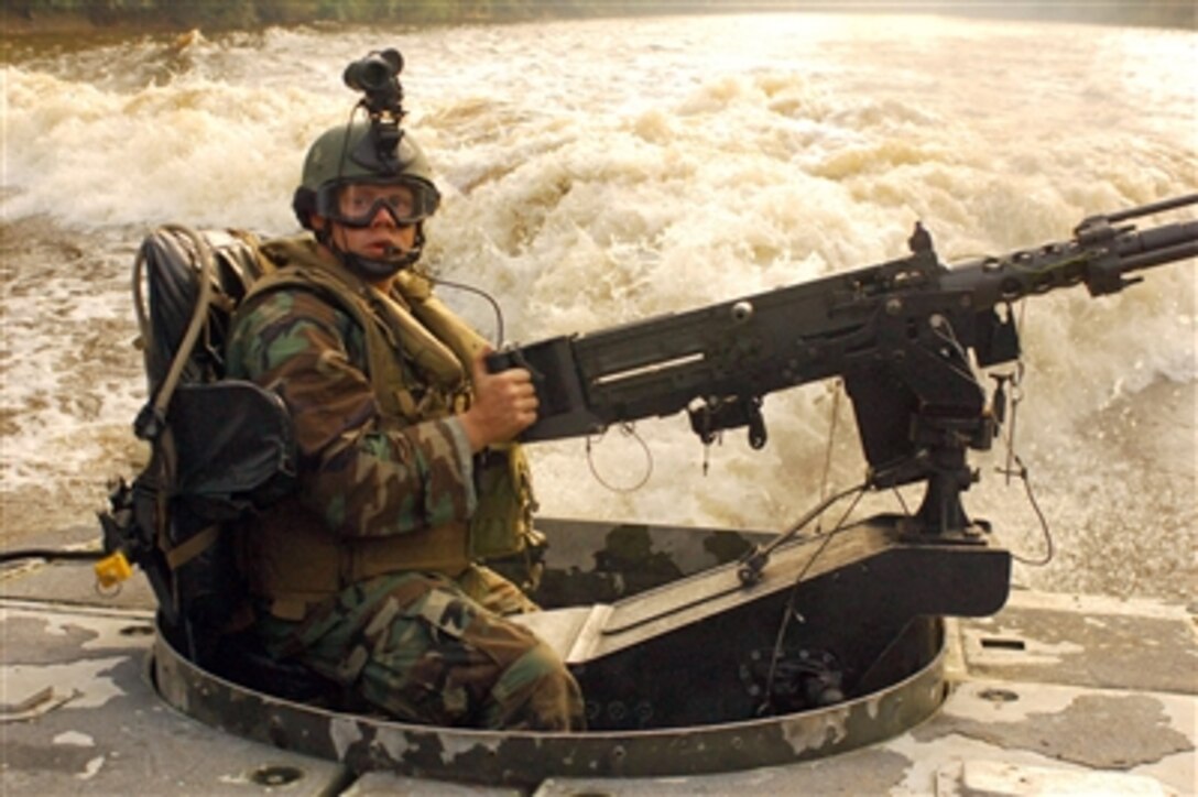 U.S. Navy Petty Officer 1st Class Joshua Jackson, assigned to Riverine Squadron 1, mans the aft .50-caliber machine gun aboard a Riverine Assault Craft during training on the Cape Fear River, N.C., Sept. 8, 2006.