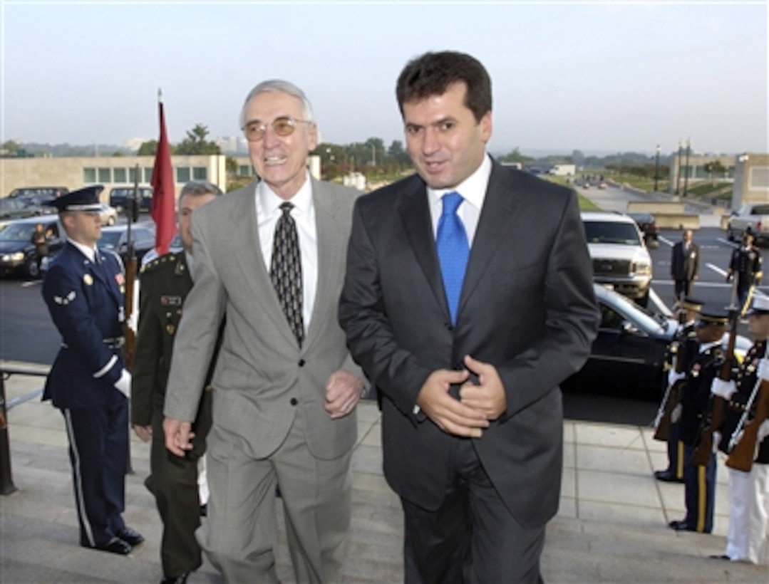 Deputy Secretary of Defense Gordon England (left) escorts Albanian Minister of Defense Fatmir Mediu through an honor cordon and into the Pentagon on Sept. 15, 2006.  England and Mediu will meet over breakfast to discuss a range of bilateral security issues.  