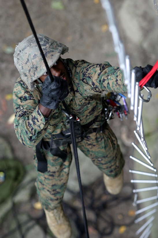 Sergeant Rodricus L. Goines, a section chief with Kilo Battery, Battalion Landing Team 2nd Bn., 2nd Marine Regiment, 26th Marine Expeditionary Unit, prepares a cable ladder fixed lane on the side of a 45-foot cliff near Greer Stone Quarry, W. Va., Sept 16, 2006, during the Rough Terrain Familiarization Course.  Using fixed lanes, a trained group of Marine climbers can quickly move a large force up or down a vertical surface.  (Official USMC photo by Lance Cpl. Jeremy T. Ross) (Released)
