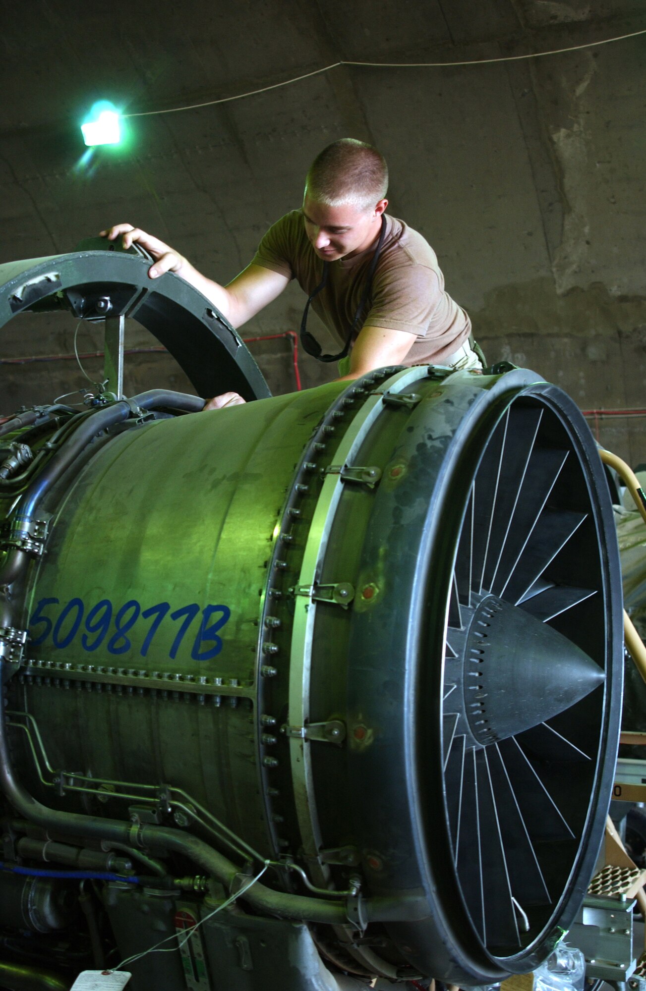 Senior Airman Joshua Harrison inspects a spare F-16 Fighting Falcon engine at Balad Air Base, Iraq. The Airman is a jet engine mechanic with the 332nd Expeditionary Aircraft Maintenance Squadron aircraft maintenance unit. (U.S. Air Force photo/Senior Airman James Croxon)