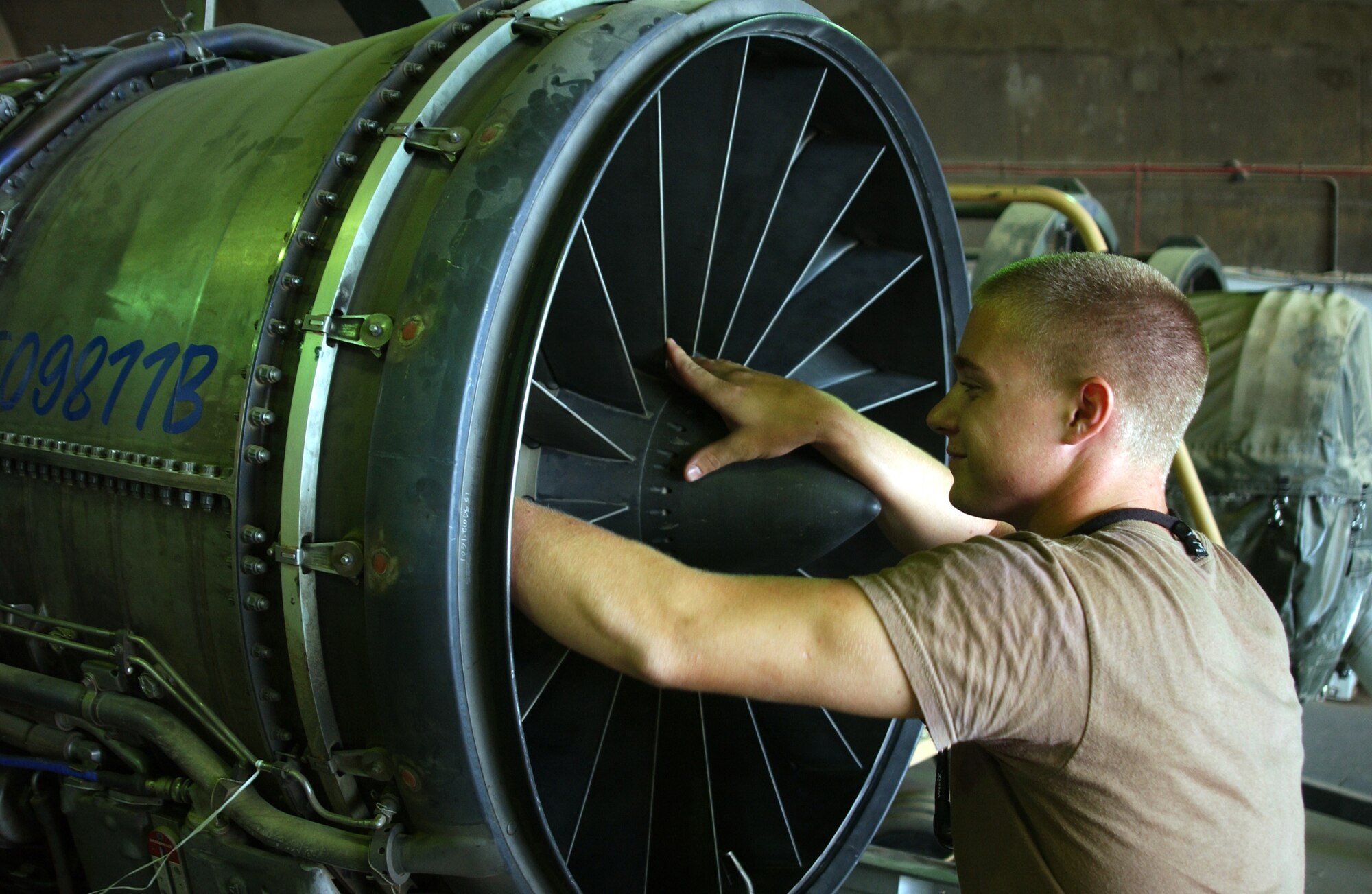 Senior Airman Joshua Harrison checks the fan blades on a spare F-16 Fighting Falcon engine at Balad Air Base, Iraq. The Airman is a jet engine mechanic with the 332nd Expeditionary Aircraft Maintenance Squadron's aircraft maintenance unit. The 332nd and 524th Expeditionary Fighter Squadrons deploy with spare engines in case of emergencies. (U.S. Air Force photo/Senior Airman James Croxon)                             