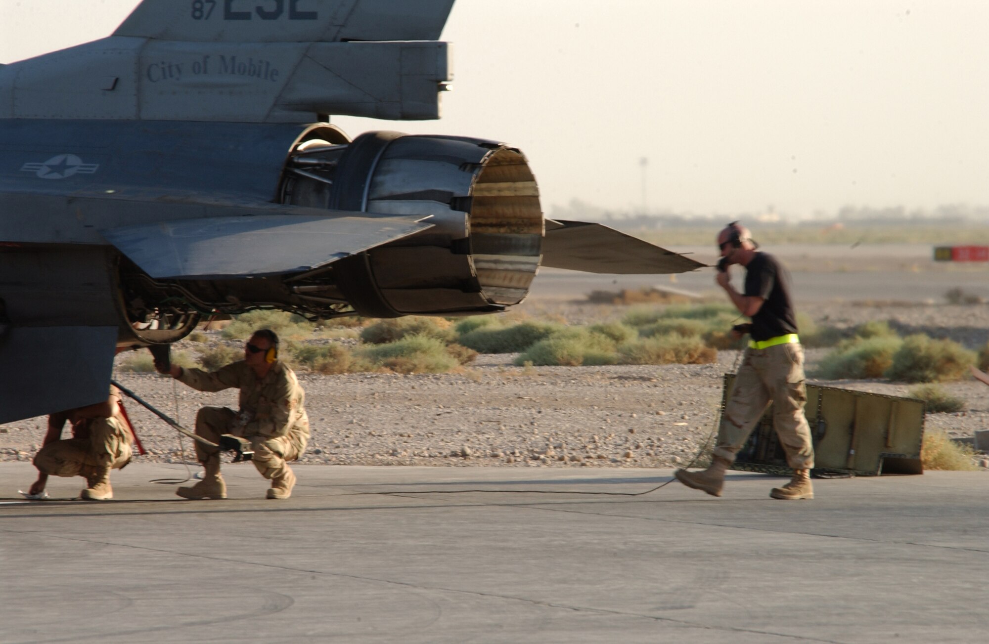 Staff Sgts. William Blackmon (center) and Charles Brown (right) test a newly installed engine on an F-16 Fighting Falcon at Balad Air Base, Iraq. The Airmen are with the 332nd Expeditionary Aircraft Maintenance Squadron aircraft maintenance unit, the Tiger. (U.S. Air Force photo/SrA Kerry Solan-Johnson)                               