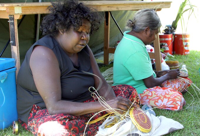 Christine Owney and Diane Bruce, Jawoyn tribe residents of the Manyallaluk/Eva Valley community, weave baskets from tree roots. According to Owney, a basket can take two days to a month to complete.