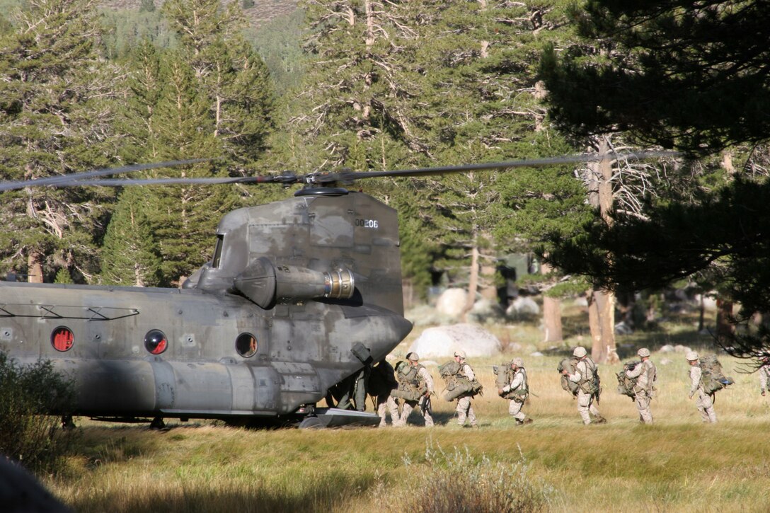MARINE CORPS MOUNTAIN WARFARE TRAINING CENTER BRIDGEPORT, Calif.- Marines of Lima Company, 3rd Battalion, 7th Marine Regiment, board a CH-47 "Chinook" at Landing Zone Penguin with full combat load to be transported to Lower Base Camp after securing the area from hostile forces during 3/7?s final exercise at the Marine Corps Mountain Warfare Training Center in Bridgeport, Calif., Sept. 18.