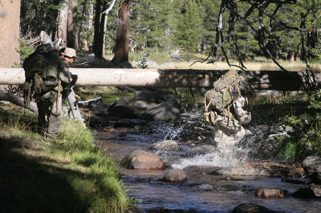 Lance Cpl. Jimmy Saunders, Company L, 3rd Battalion, 7th Marine Regiment, splashes across a stream with a full combat load during 3/7?s final exercise at the Marine Corps Mountain Warfare Training Center in Bridgeport, Calif., Sept. 18.