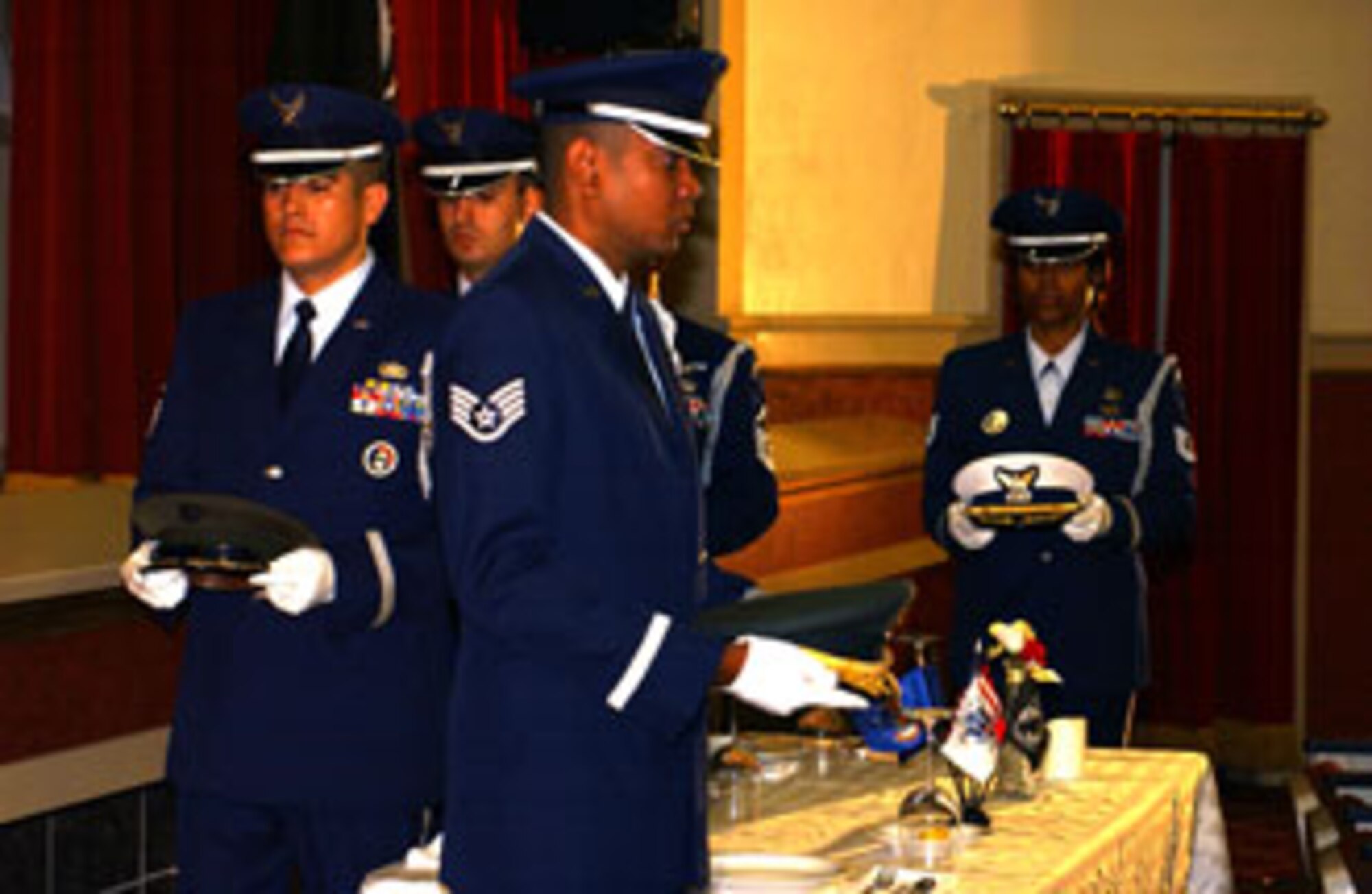 Member of the Total Force Blue Eagles Honor Guard conduct the POW/MIA table presentation during the base's annual POW/MIA remembrance ceremony on Friday, September 15, 2006 at March Air Reserve Base.  Veterans' groups, local dignitaries and installation members attended the event.  (U.S. Air Force photo by Staff Sgt. Amy Abbott, 452 AMW/Public Affairs)