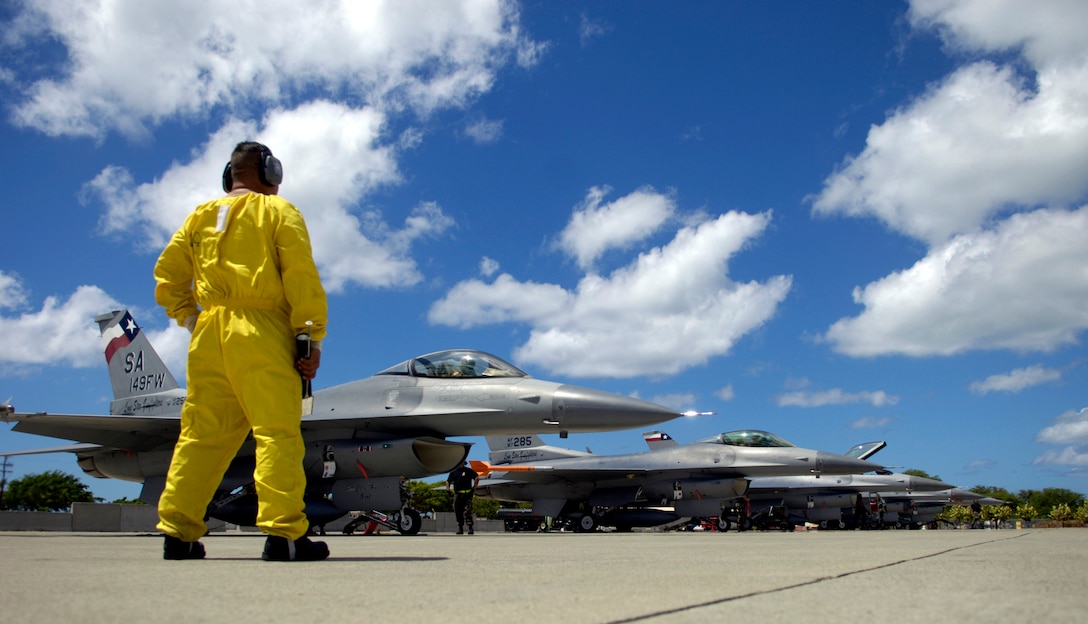 Tech. Sgt. Gerardo Guevara waits for F-16 Fighting Falcons to shut down their engines before conducting post-flight checks at Hickam Air Force Base, Hawaii, Sept. 8. Six F-16s from the Texas Air National Guard's 149th Fighter Wing came to Hickam AFB to participate in Exercise Sentry Aloha. Sergeant Guevara is a maintainer from the 149th FW. (U.S. Air Force photo/Tech. Sgt. Shane A. Cuomo)