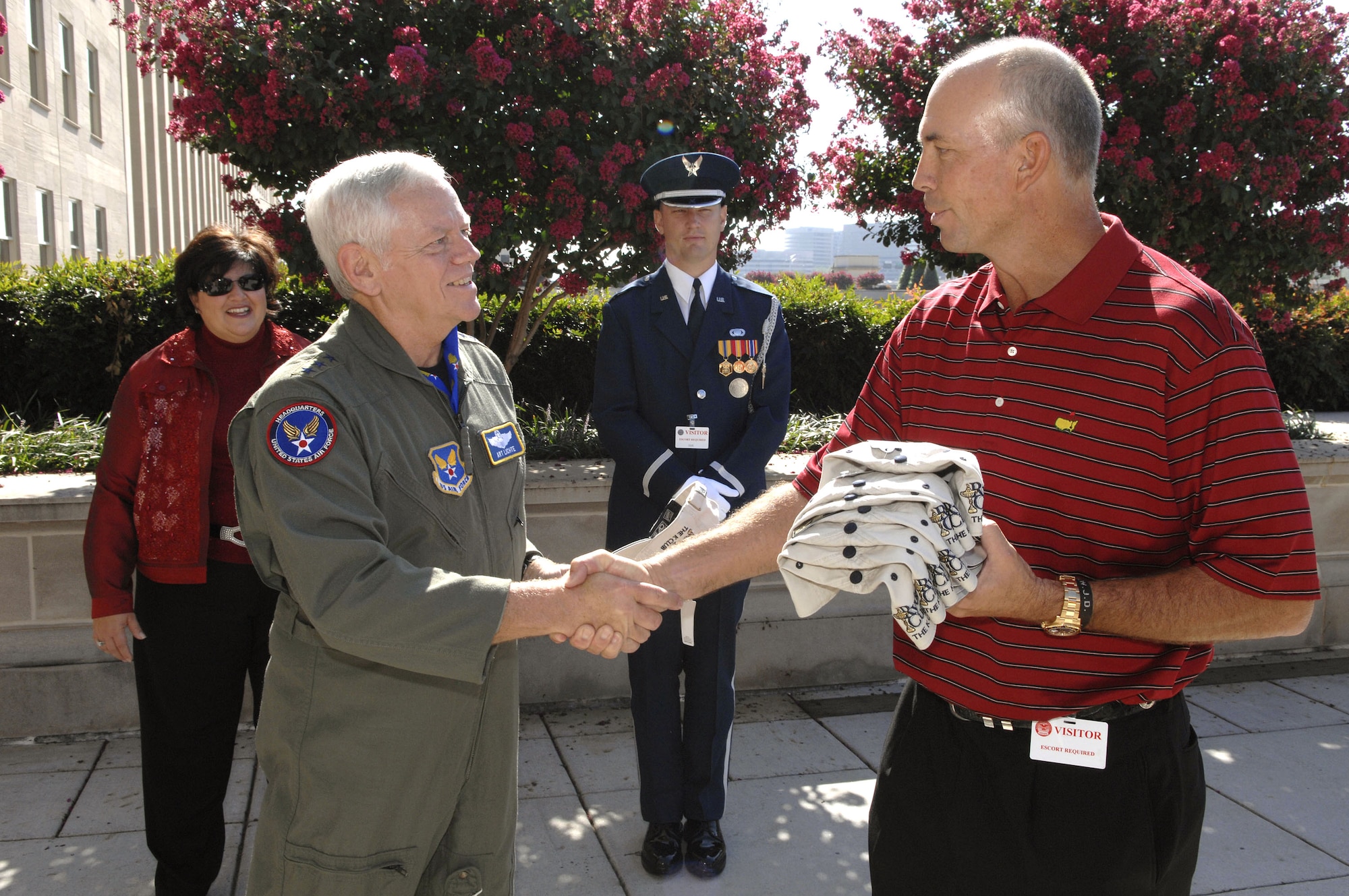 U.S. Ryder Cup Captain Tom Lehman shakes hands with Lt. Gen. Arthur J. Lichte after the two exchanged mementos from the Ryder Cup team's visit at the Pentagon Sept. 17. The team then visited wounded servicemembers at Walter Reed Army Medical Center. (U.S. Air Force photo/Tech. Sgt. Cohen A. Young)
