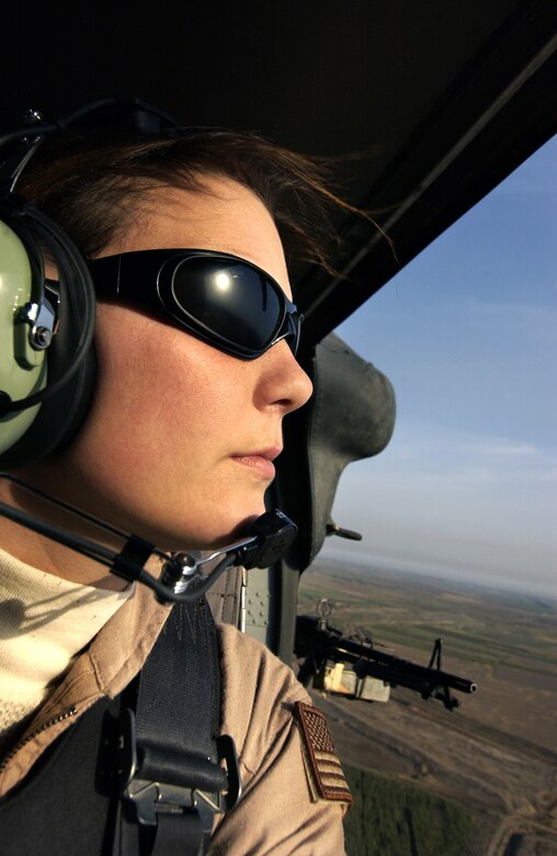 Staff Sgt. Stacy Pearsall shot this self-portrait Nov. 11, 2003, while flying over the Iraqi countryside near Babylon. Sergeant Pearsall is an aerial combat photojournalist with the 1st Combat Camera Squadron at Charleston Air Force Base, S.C. She is featured on the cover of the October issue of Pink, a magazine targeting women executives, professionals and business owners, which hits newsstands Sept. 19. (U.S. Air Force photo)
