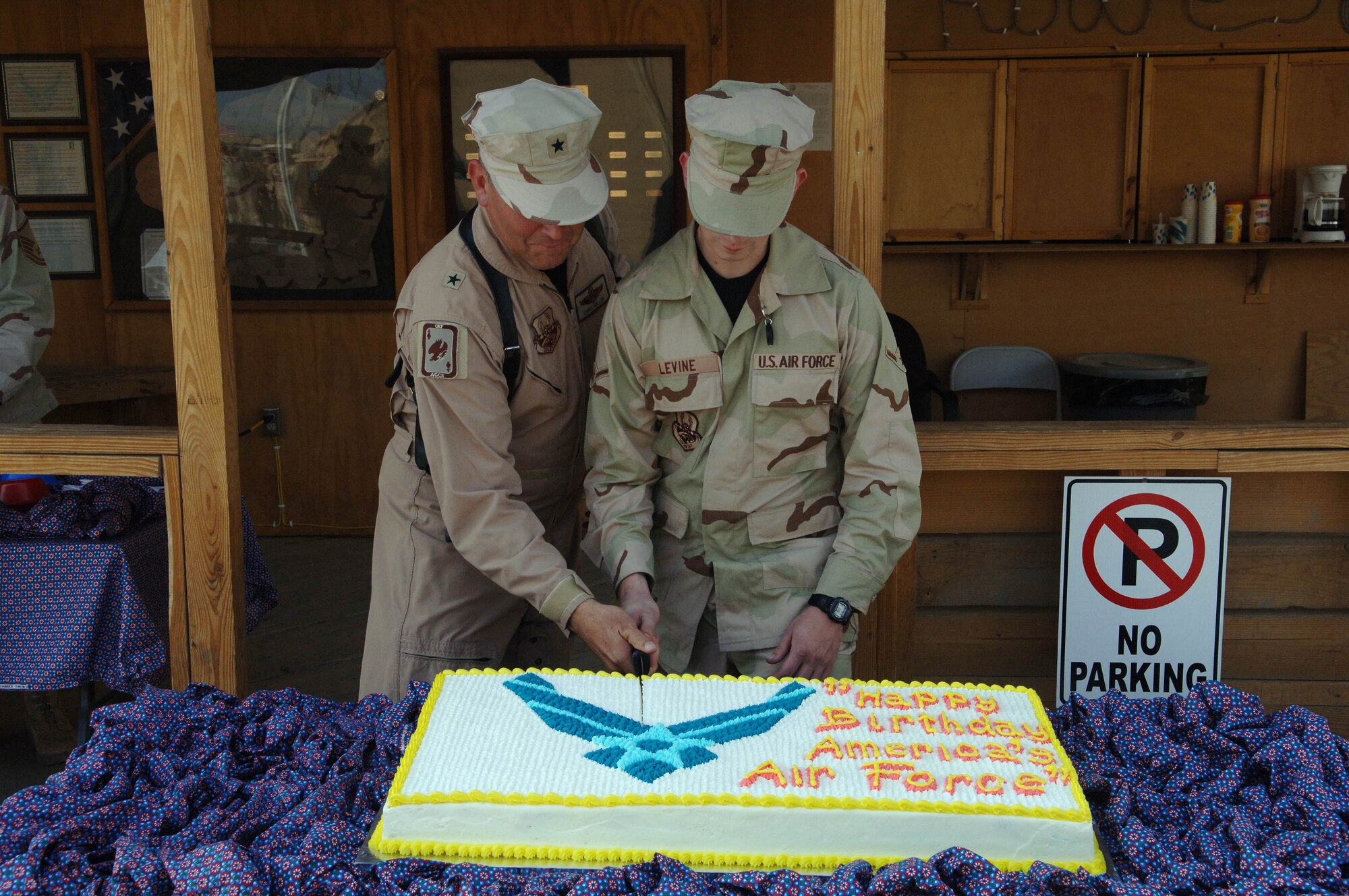 Brig. Gen. Christopher Miller, 455th Air Expeditionary Wing commander, and Airman Nicholas Levine, a crew chief with the 455th Expeditionary Maintenance Squadron, cut the annual Air Force birthday cake.  Tradition states the cake be cut by the most senior officer and the youngest airman. (U.S. Air Force photo/Tech. Sgt. Joseph Kapinos)