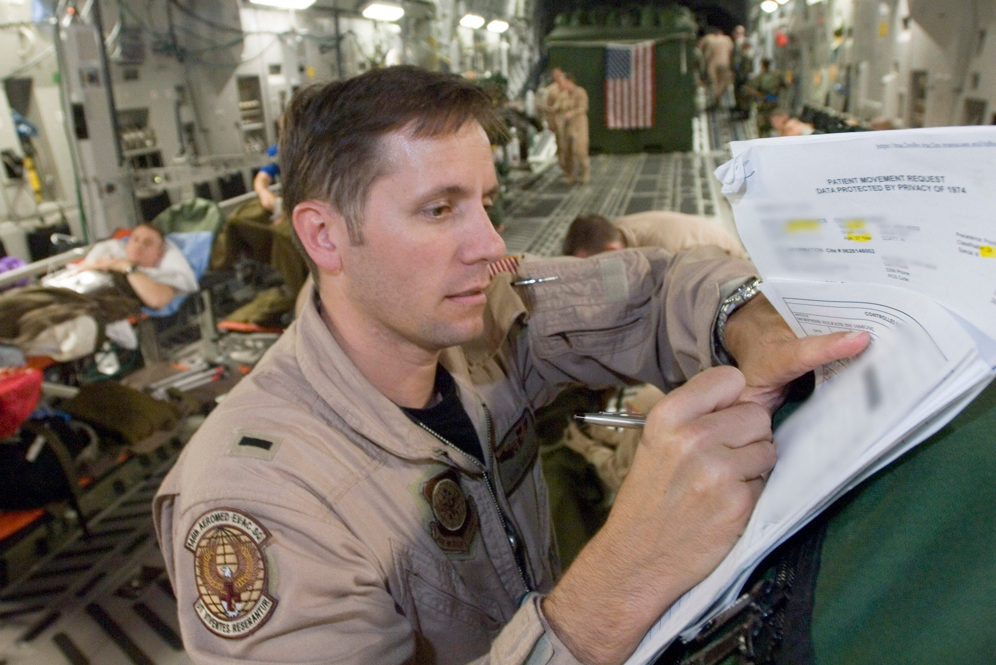 First Lt. John Rinaldo annotates a patient's records after completing an aeromedical evacuation mission on a C-17 Globemaster III Sept. 18. Lieutenant Rinaldo is a flight nurse with the 791st Expeditionary Aeromedical Evacuation Squadron supporting operations Iraqi Freedom and Enduring Freedom. (U.S. Air Force photo/Master Sgt. John E. Lasky)