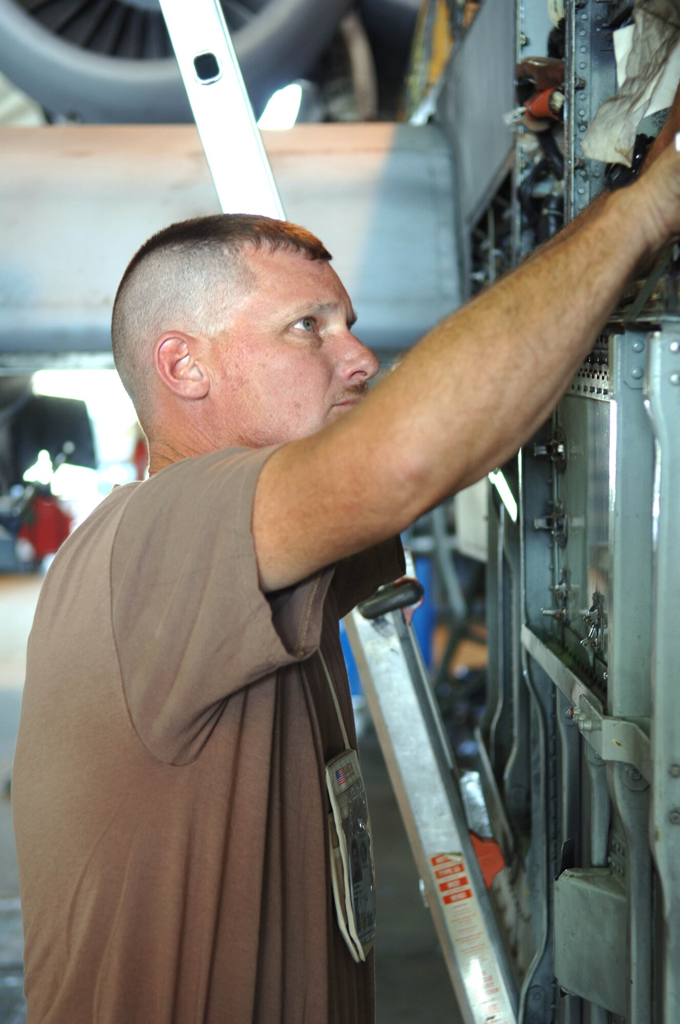 Staff Sergeant Daniel Boughton, 455th Expeditionary Maintenance Squadron, works on the avionics section of an A-10 Thunderbolt II, often called the "Warthog" by pilots and maintainers alike.  The aircraft was going through an extended maintenance overhaul before being returned to the line. (U.S. Air Force photo/Tech. Sgt. Joseph Kapinos)