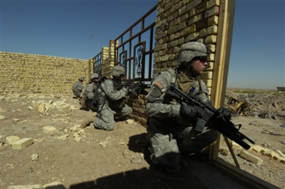 U.S. Army soldiers scan an open field before crossing it during a cordon and search mission in Ur, Iraq, on Sept. 14, 2006.  The soldiers are assigned to Bravo Company, 1st Battalion, 17th Infantry Regiment, 172nd Stryker Brigade Combat Team. 