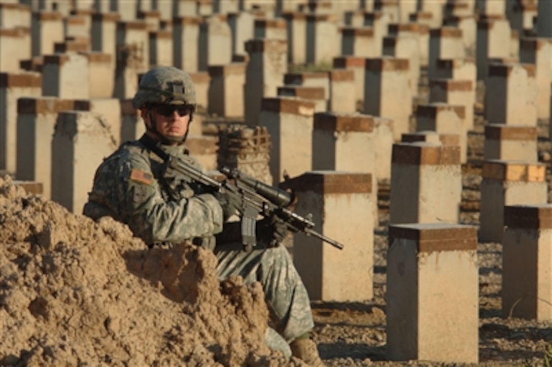 U.S. Army Staff Sgt. Cody Stowe stops to visually scan the immediate area during a cordon and search mission in Ur, Iraq, on Sept. 14, 2006.  Stowe is assigned to Bravo Company, 1st Battalion, 17th Infantry Regiment, 172nd Stryker Brigade Combat Team.  