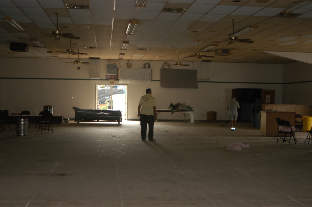 Members of the Veterans of Foreign Wars Post 7194 assess the damage after Hurricane Katrina. Marines from MarForRes helped clean out the post Sept. 18.
