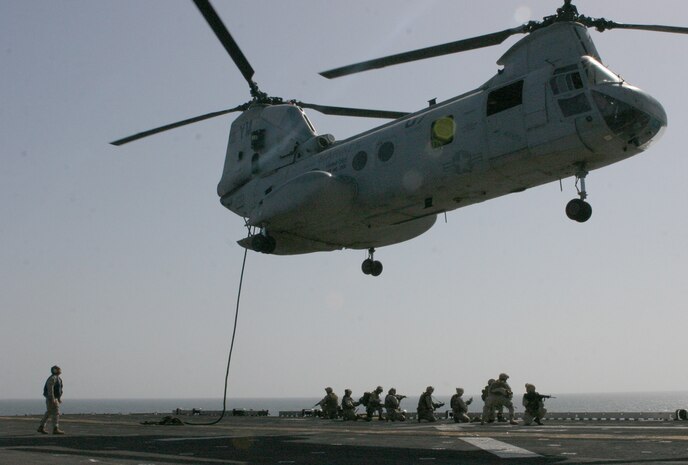 Marines from Battalion Landing Team 1st Battalion, 8th Marine Regiment, 24th Marine Expeditionary Unit perform a fast-roping exercise during a Vessel Boarding Search and Seizure training mission onto the flight deck of the USS Iwo Jima. Exercises like these prepare Marines to enter combat situations where the aid of helicopters can not be used for an extended period of time. (US Marine Corps photo by Lance Corporal Andrew J. Carlson)