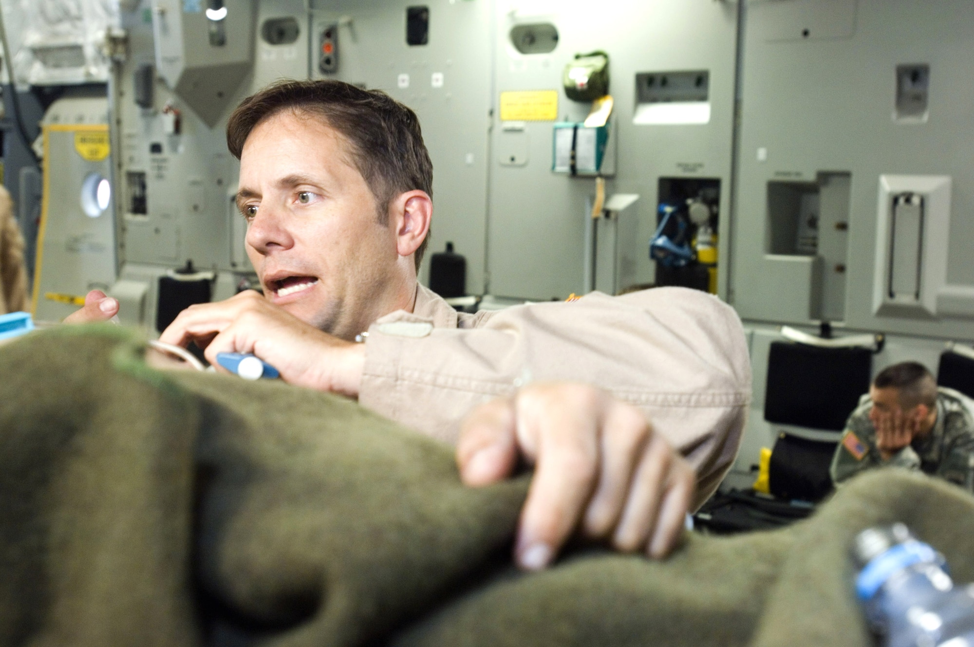 First Lt. John Rinaldo administers medicine during an aeromedical evacuation mission Sept. 18 aboard a C-17 Globemaster III. Lieutenant Rinaldo is a flight nurse serving temporary duty with the 791st Expeditionary Aeromedical Evacuation Squadron at Ramstein Air Base, Germany. (U.S. Air Force photo/Master Sgt. John E. Lasky)

