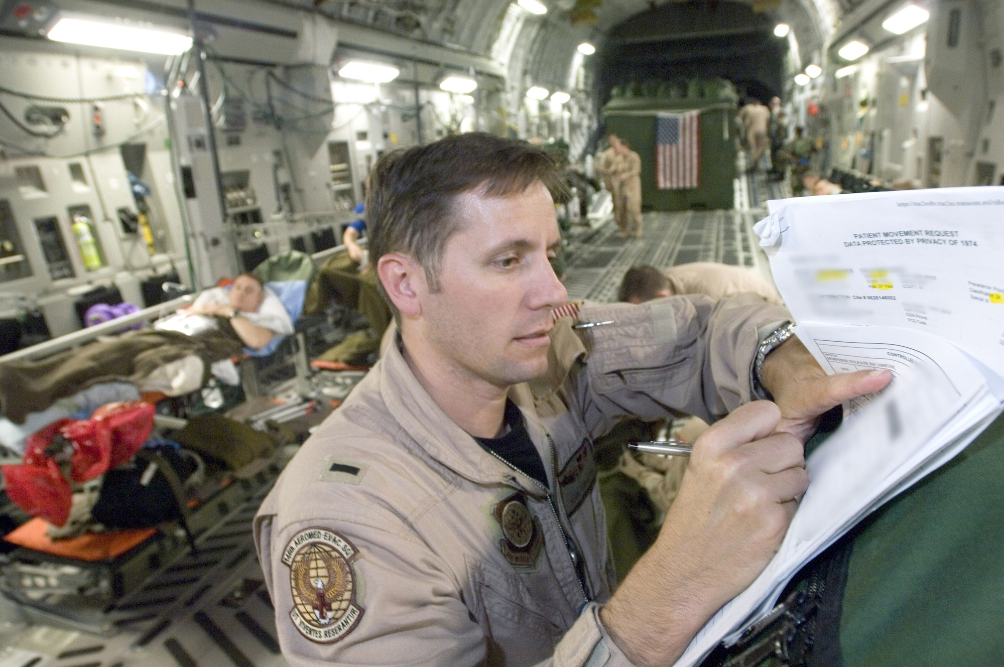 First Lt. John Rinaldo annotates a patient's records after completing an aeromedical evacuation mission Sept. 18 on a C-17 Globemaster III. Lieutenant Rinaldo is a flight nurse serving temporary duty with the 791st Expeditionary Aeromedical Evacuation Squadron at Ramstein Air Base, Germany. (U.S. Air Force photo/Master Sgt. John E. Lasky) 
