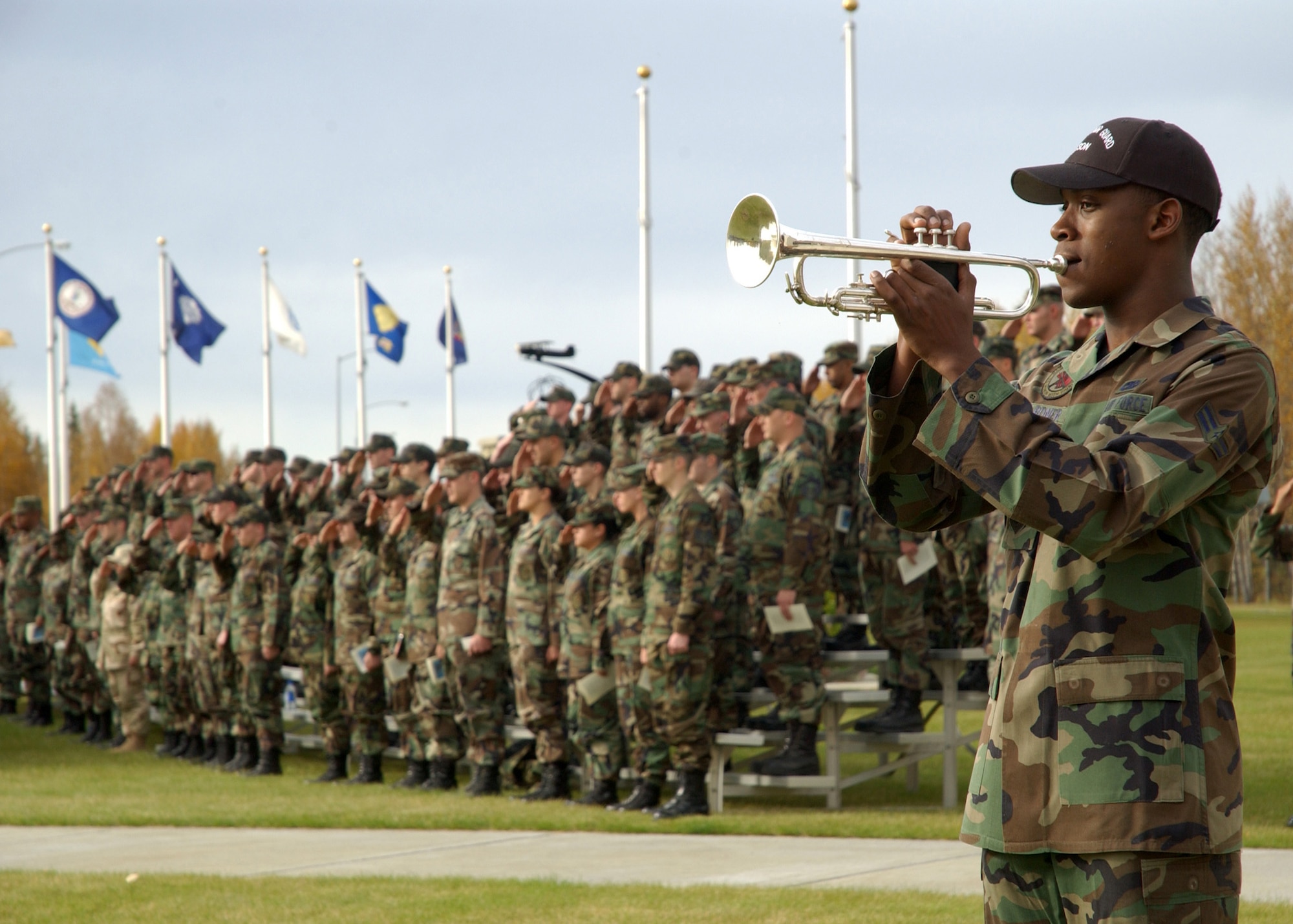 Airman 1st Class Ramsey Gardner, Eielson AFB Honor Guard member, plays Taps in recognition of American prisoners of war and those missing in action during the National POW/MIA Recognition Day ceremony at Heritage Park here Friday.  The 354th Fighter Wing assembled in formation at the park to pay homage to lost comrades and participate in a wing retreat ceremony.  (U.S. Air Force Photo by Airman Jonathan Snyder)
