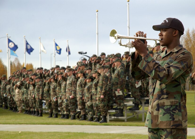 Airman 1st Class Ramsey Gardner, Eielson AFB Honor Guard member, plays Taps in recognition of American prisoners of war and those missing in action during the National POW/MIA Recognition Day ceremony at Heritage Park here Friday.  The 354th Fighter Wing assembled in formation at the park to pay homage to lost comrades and participate in a wing retreat ceremony.  (U.S. Air Force Photo by Airman Jonathan Snyder)

