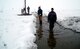 STATION NORD, Greenland — Second Lt. Isseyas Mengistu (background), 1st Lt. Robert Esposito (middle) and Jake Quinn, researchers serving with the Air Force Research Laboratory, Space Vehicles Directorate, lay out the ionosonde antenna elements on the frozen tundra of Greenland prior to hoisting them up an 82-foot pole.  (Air Force photo)