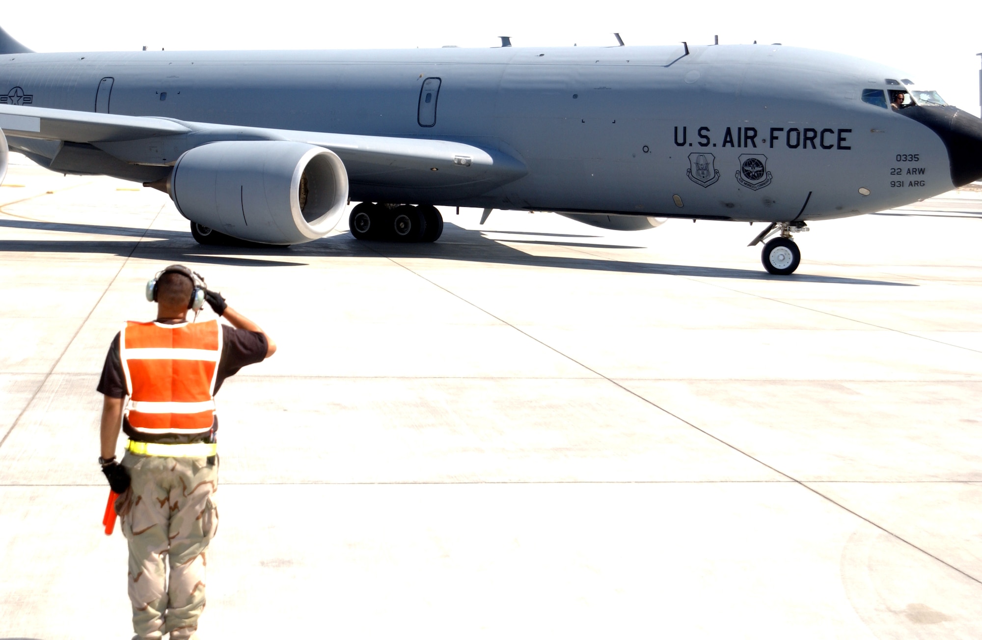 Senior Airman Ismael Hernandez salutes the crew of a KC-135 Stratotanker from the 380th Air Expeditionary Wing as it taxis at a forward-operating base in Southwest Asia. The 380th AEW is home to the largest air refueling squadron in the theater of operations. Airman Hernandez is assigned to the 380th Expeditionary Aircraft Maintenance Squadron. (U.S. Air Force photo/Master Sgt. Jason Tudor)

