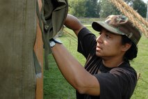 YOUNGSTOWN AIR RESERVE STATION, Ohio -- Air Force Reserve Master Sergeant Betty Castillo, a personnel craftsman with the 910th Civil Engineer Squdron, assists in putting up a tent during the squadron's Sept. 9-10 bivouac training exercise here.  U.S. Air Force photo/Master Sgt. Bryan Ripple