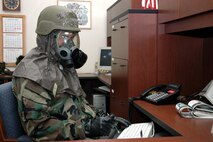 YOUNGSTOWN AIR RESERVE STATION, Ohio -- Air Force Reserve Senior Airman Doug Lind, a personnel journeyman with the 910th Civil Engineer Squadron, practices office skills while in MOPP 4 during the squadron's Sep. 9-10 bivouac.  U.S. Air Force photo/Master Sgt. Bryan Ripple