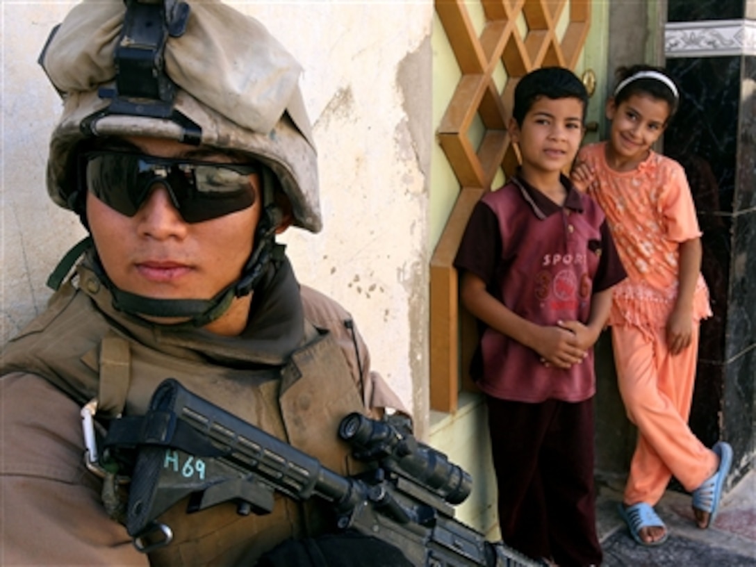 U.S. Marine Lance Cpl. Youngjun Choi, 25th Marine Regiment, Regimental Combat Team 5, provides security as fellow Marines search a house during Operation Matador in Fallujah, Iraq, Sept. 13, 2006.  The Marines and Iraqi security forces swept the Andaloos District of Fallujah to disrupt insurgent activity.