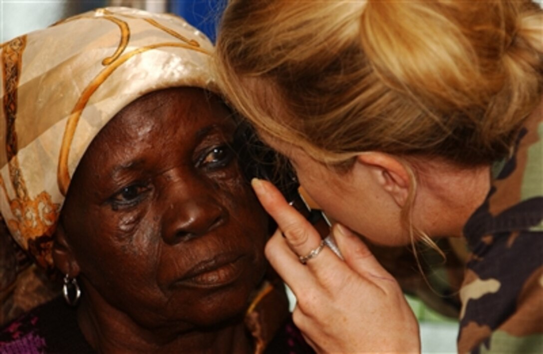 U.S. Air Force Capt. Christy Barton performs a cataract test on a Ghanaian woman in Tamale, Ghana, during Exercise Med Flag 2006 on Sept. 12, 2006.  Med Flag is a medical-training exercise in which medical personnel from U.S. Air Forces in Europe are treating residents and training local health care workers.  Barton is an optometrist assigned to the 52nd Medical Group.  