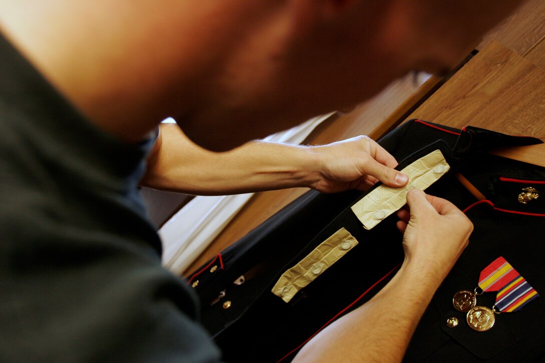 MARINE BARRACKS WASHINGTON ? Cpl. Josh Leuthold, a 22-year-old Reno, Nev., native, sheaths a M-1 Garand rifle bayonet after drawing his gear from the armory for a morning drill practice session.