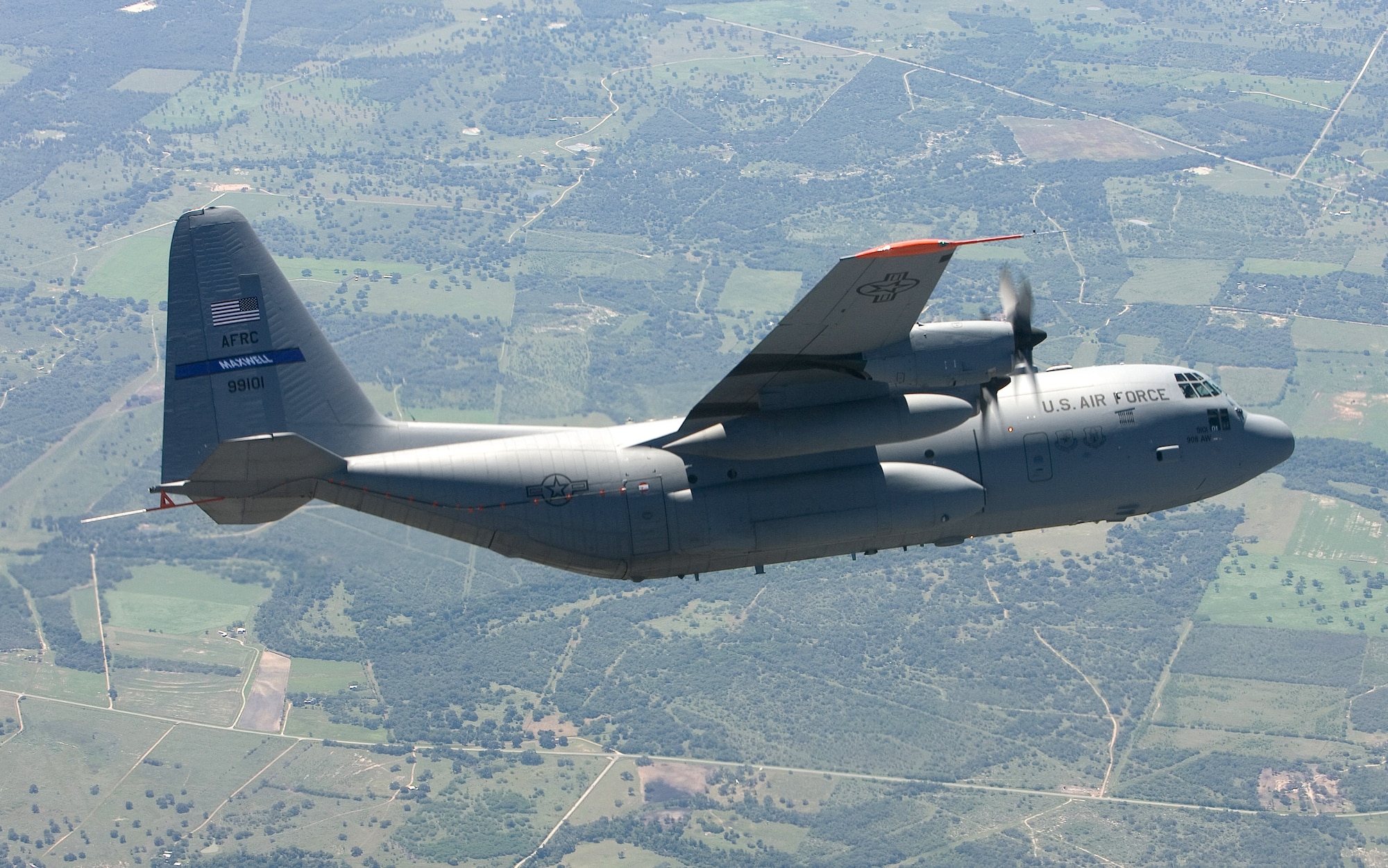 A specially modified C-130 Hercules banks over the Texas countryside Sept. 19 during its initial test flight.  The Hercules, which took off from Lackland Air Force Base, Texas, was modified under the C-130 Avionics Modernization Program which included a comprehensive upgrade of the avionics system that increases situational awareness for the warfighter tenfold over old analog cockpits, dramatically increasing information available to aircrews at a glance, simplifying tasks and decreasing workload.  (Boeing photo/Ron Bookout)