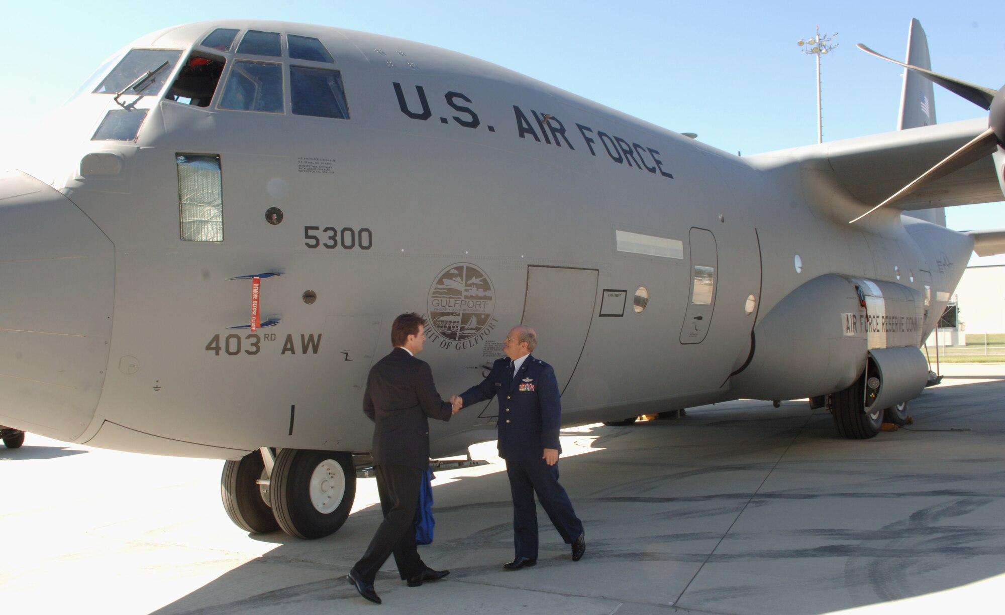 Mayor Brent Warr, Gulfport, and Brig. Gen. Richard Moss unveil the city's logo on a WC-130J "Hurricane Hunter" aircraft during dedication ceremonies Sept. 20, 2006. Aircraft are named "The Spirit of," to remind the aircrew they carry with them on each flight the hopes and prayers of their fellow citizens and to remind the community this aircraft and aircrew are dedicated to protecting their way of life.