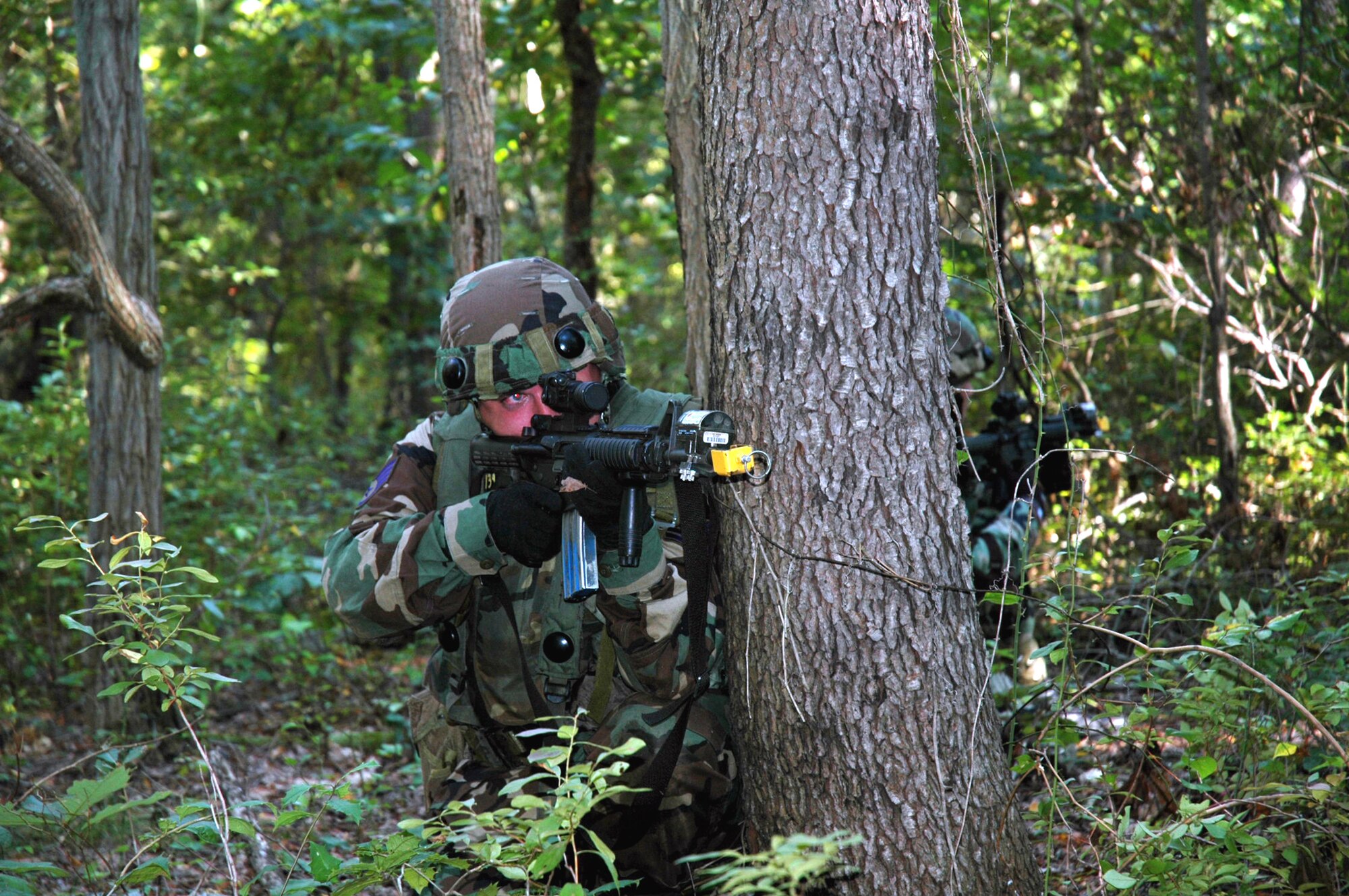 Staff Sgt. Gregory Hasecuster and other students in the Air Mobility Warfare Center's Advanced Contingency Skills Training Course 06-5 at Fort Dix, N.J., practice combat patrolling during a training session at a tactical range there Sept. 18. More than 60 Airmen are participating in the training course, learning numerous combat-related skills including tactics, media skills, convoy operations, first aid, and field craft. The course is taught by the AMWC's 421st Combat Training Squadron.  (U.S. Air Force photo/Tech. Sgt. Scott T. Sturkol)