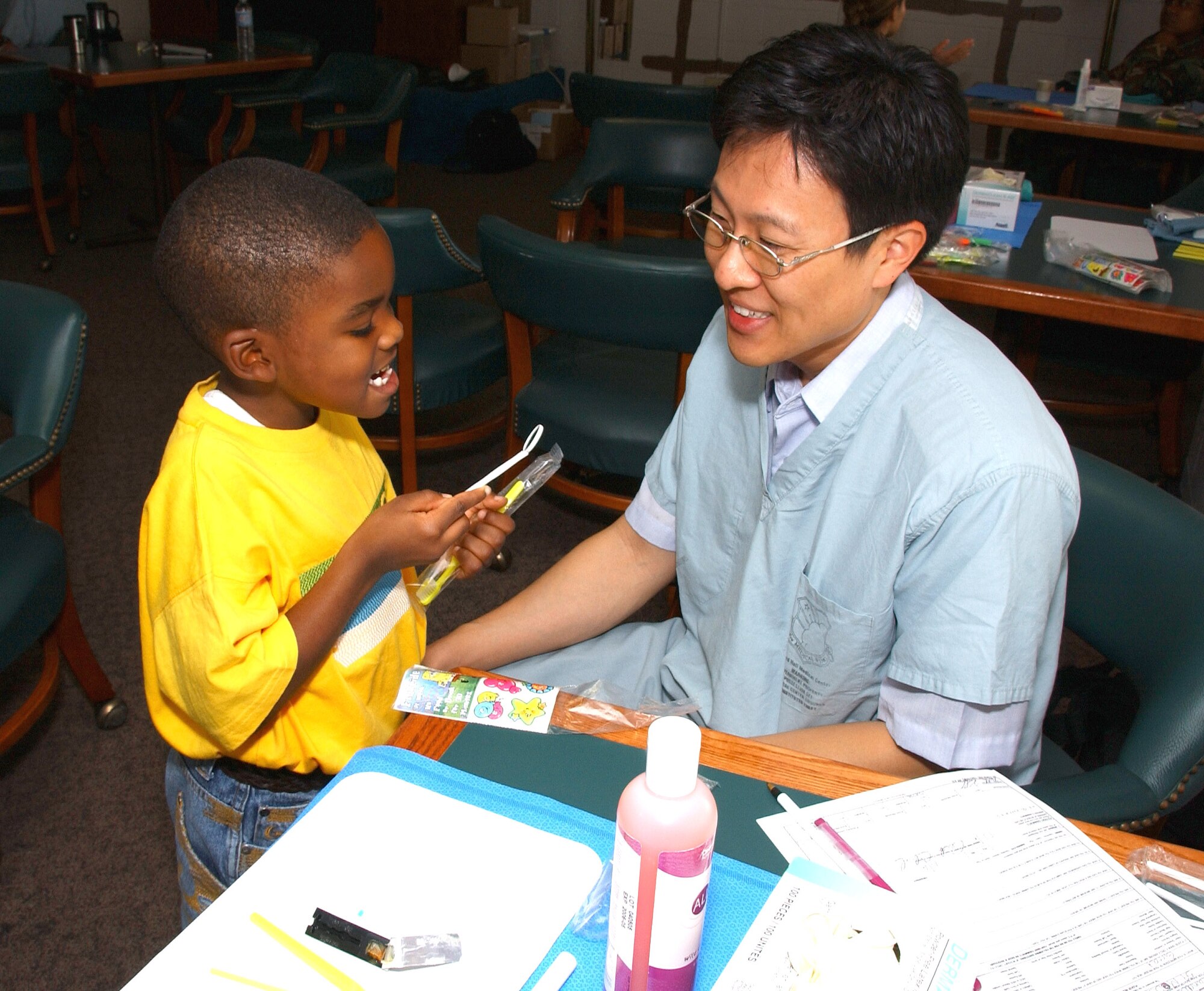 Capt. Jaesuk Yoo lets Ross Chandler apply a fluoride treatment to his teeth Sept. 13 at Lackland Air Force Base, Texas. Captain Yoo is a Pediatric Dental Course resident from Osan Air Base, South Korea. Ross is the son of Senior Airman Cabrille Chandler, a 59th Medical Wing Support Squadron referral clerk at Lackland AFB. (U.S. Air Force photo/Master Sgt. Kimberly Yearyean-Siers)