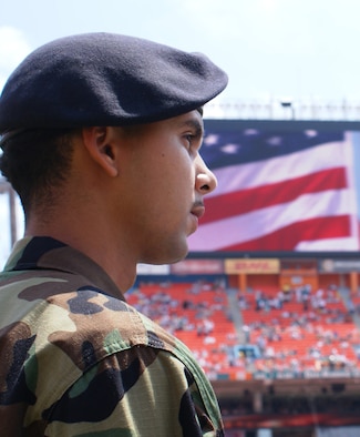 Senior Airman Julian DeJesus III, 482nd Security Forces, was one of 50 reservists of Homestead Air Reserve Base, Fla. to take part in a tribute to military members during opening ceremonies of the Dolphins first home-game of the season Sep. 17. The Airmen joined about 150 soldiers and sailors from South Florida unfurling an enormous field-size American Flag at the event. (Air Force photo by Dan Galindo)