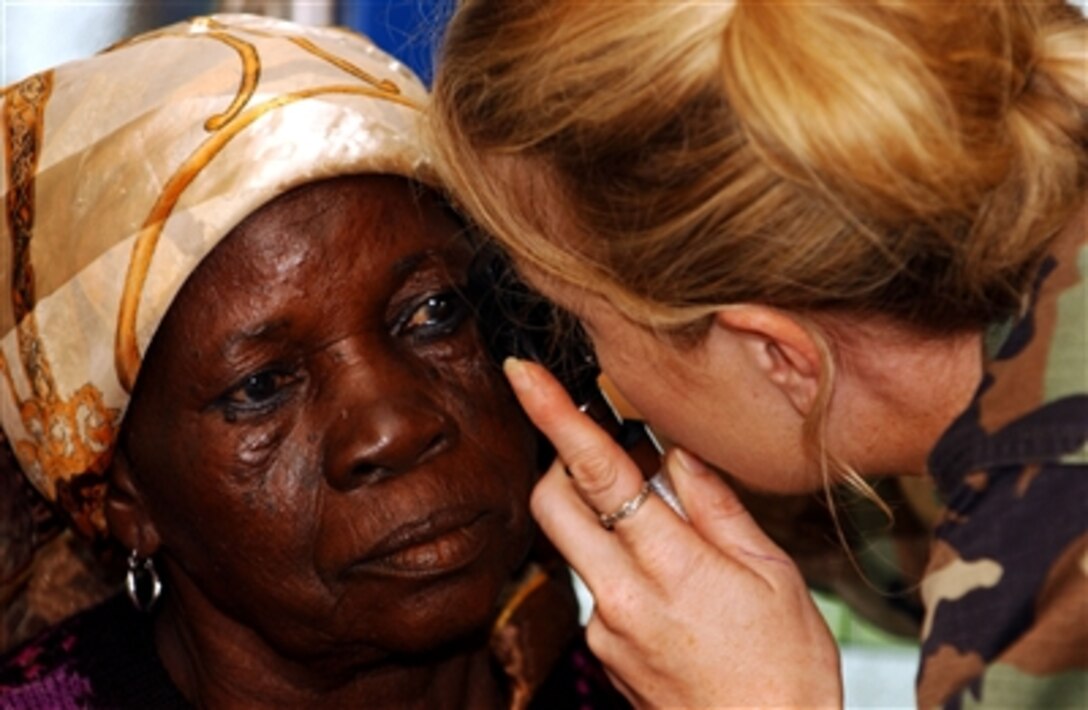 U.S. Air Force Capt. Christy Barton performs a cataract test on a Ghanaian woman in Tamale, Ghana, during Exercise Med Flag 2006, Sept. 12, 2006.  Med Flag is a medical-training exercise in which medical personnel from U.S. Air Forces in Europe are treating residents and training local health care workers.