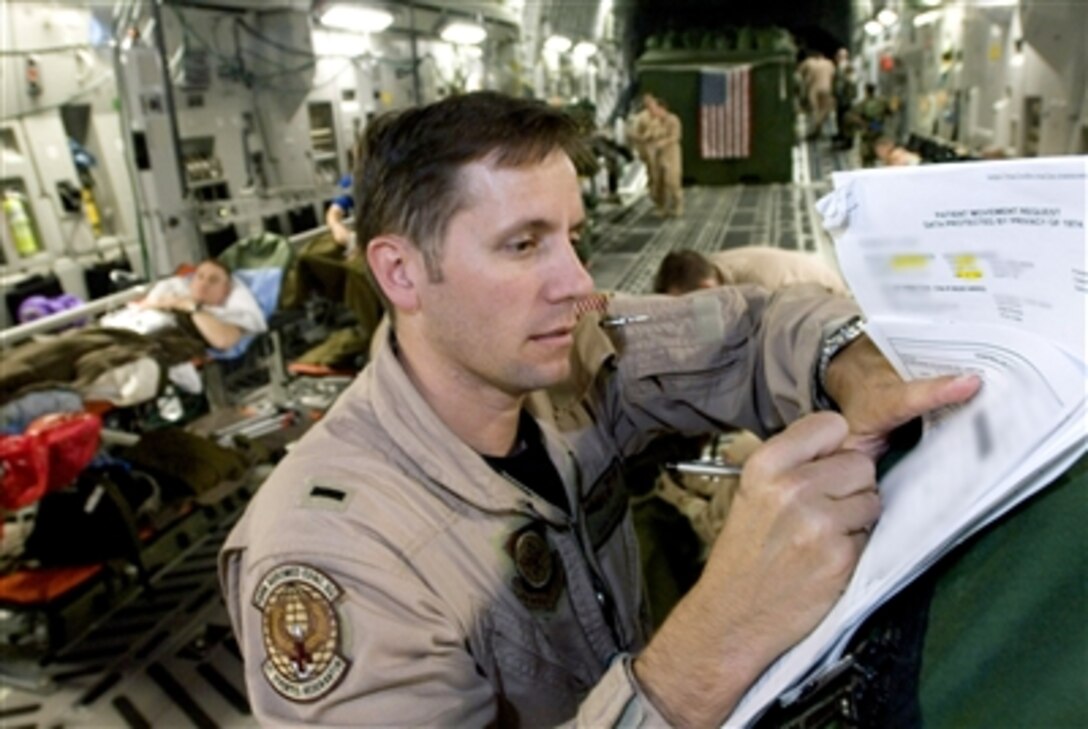 U.S. Air Force 1st Lt. John Rinaldo annotates a patient record after completing an aeromedical evacuation mission on a C-17 Globemaster III, Sept. 18, 2006.  Rinaldo is a flight nurse with the 791st Expeditionary Aeromedical Evacuation Squadron at Ramstein Air Base, Germany.