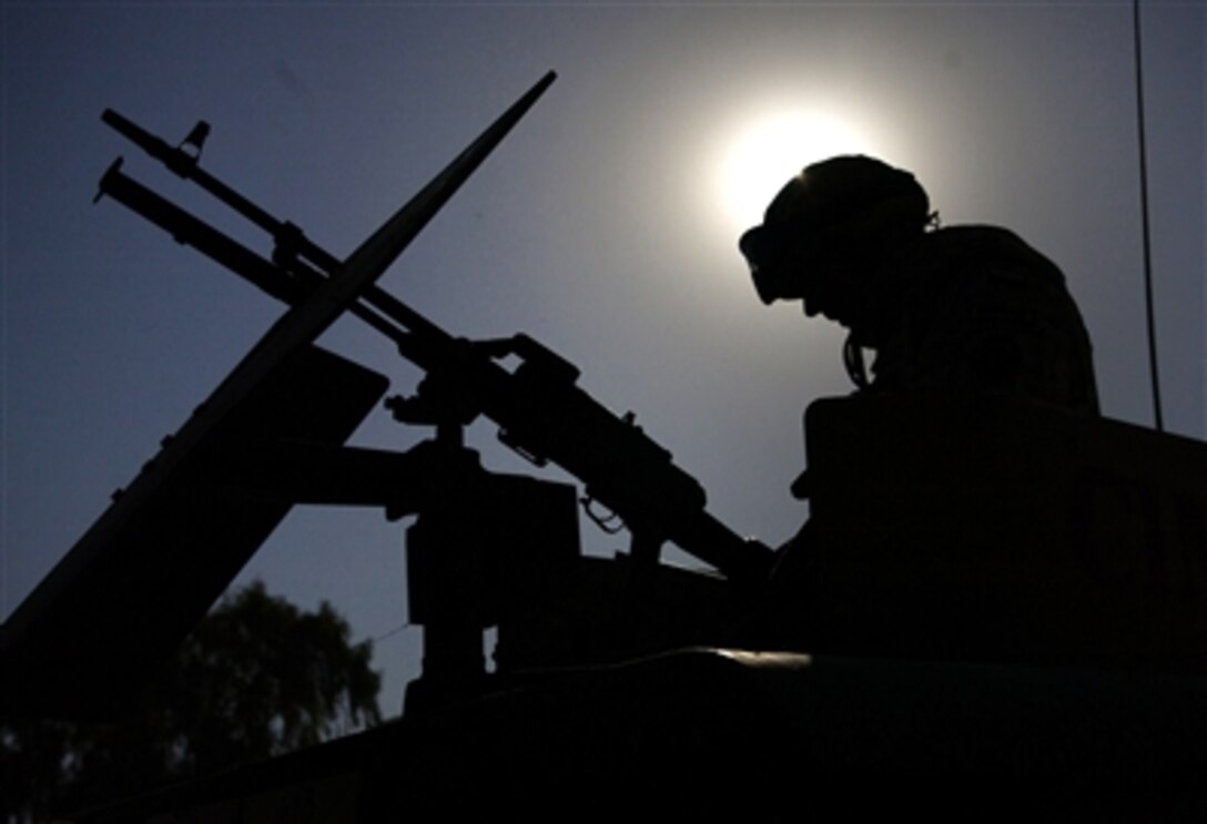 A Polish army soldier from the Polish Civil Military Cooperation based at Camp Echo, Iraq, prepares his equipment prior to a convoy mission to deliver medical supplies to the 8th Iraqi Army Division in Diwaniyah, Iraq, Sept. 14, 2006. 