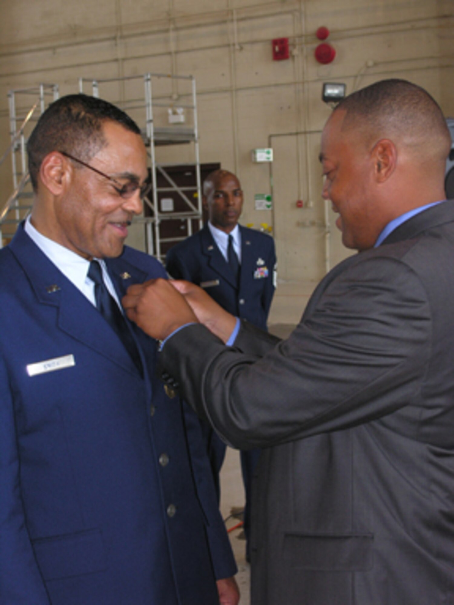 Command Chief Master Sgt. Thomas Smith receives his retirement pin from his son, Derrick J. Smith. Chief Smith joined the Air Force in May 1967 after graduating from McKinley Senior High School, Baton Rouge, La. In December 1974, he joined the Air Force Reserve at Barksdale Air Force Base, La. Chief Smith became the first sergeant for the 916th Consolidated Aircraft Maintenance Squadron in October 1987 and became the command chief master sergeant for the 916th Air Refueling Wing in April 2002. Chief Smith's most noteworthy award was the George W. Bush Presidential Citation Award for work with the Knoxville, Tenn., role model program. He has also received the Military Outstanding Volunteer Service Medal for the extensive contributions made to youth.