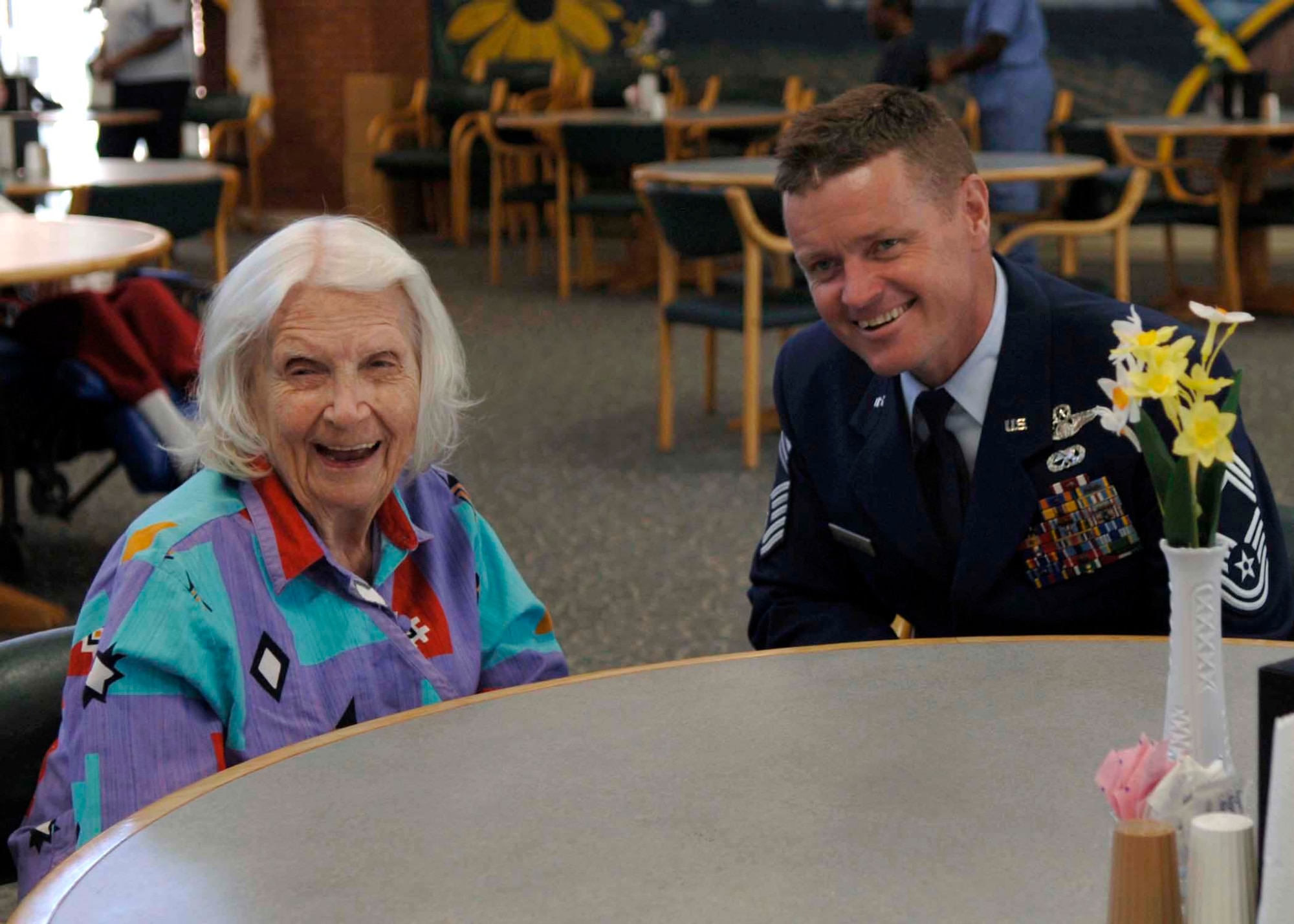 Barbara Poole Shoemaker and Chief Master Sgt. Anthony Manson share stories about her flying days in the Women's Auxiliary Ferrying Squadron in 1942.  She was also a member of the Women Airforce Service Pilots. Airmen from Andrews Air Force Base, Md., visited veterans at Charlotte Hall Veterans Home in Charlotte Hall, Md., Sept. 18.  Chief Manson is the 316th Operations Group superintendent at Andrews. (U.S. Air Force photo/Airman 1st Class Laura N. Cirksena)