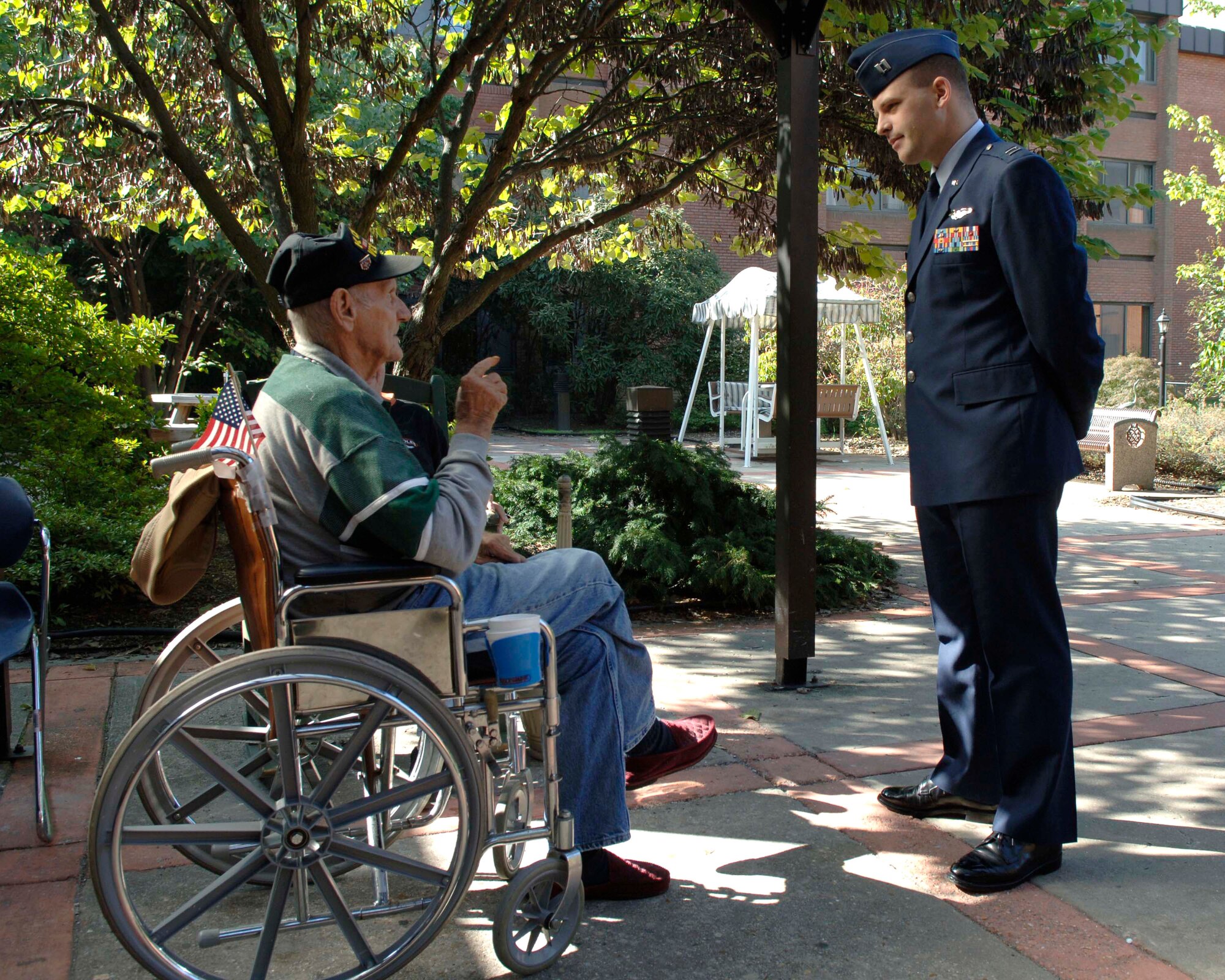 Retired Marine Staff Sgt. Edward Mahilik and Capt. Ryan Campbell talk about Mr. Mahilik's time in the service during the Korean War.  Airmen from Andrews Air Force Base, Md., visited Charlotte Hall Veterans Home in Charlotte Hall, Md., Sept. 18.  Captain Campbell is commander of the 1st Helicopter Squadron Training Flight at Andrews.  (U.S. Air Force photo/Airman 1st Class Laura N. Cirksena)