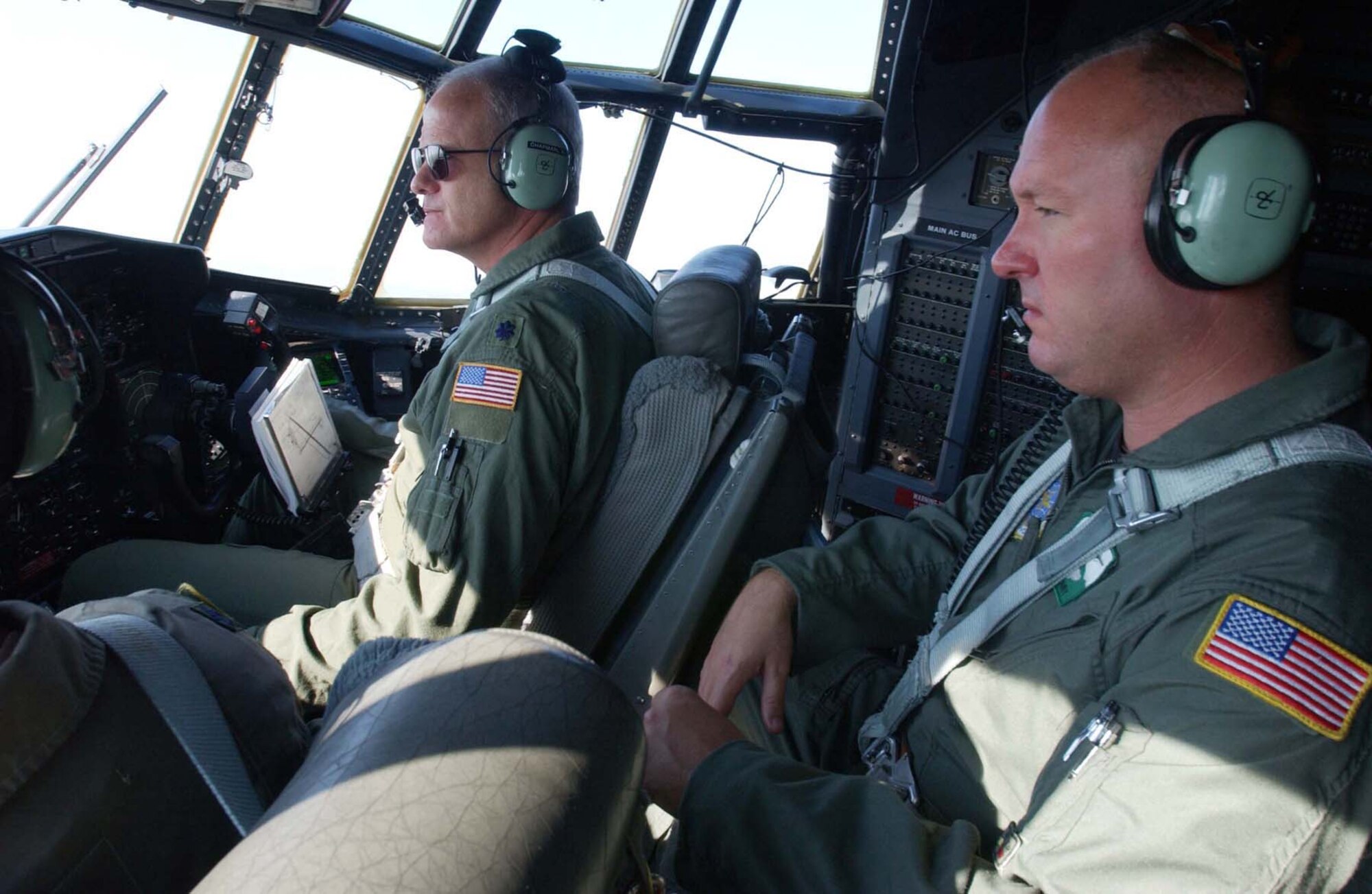 KLAMATH FALLS, Ore. (AFRC) -- Lt. Col. Bob Chapman (left), 731st Airlift Squadron commander, and Tech. Sgt. Daniel Bumby, 731st AS flight engineer, fly a Modular Airborne Fire Fighting System mission against wildfires in Nevada Sept. 6. The 302nd Airlift Wing flew 18 MAFFS sorties in the Pacific Northwest in early September in support of the USDA Forest Service, dropping 48,600 gallons of retardant. (U.S. Air Force photo by Tech. Sgt. Lee Harshman, 4th Combat Camera Squadron)