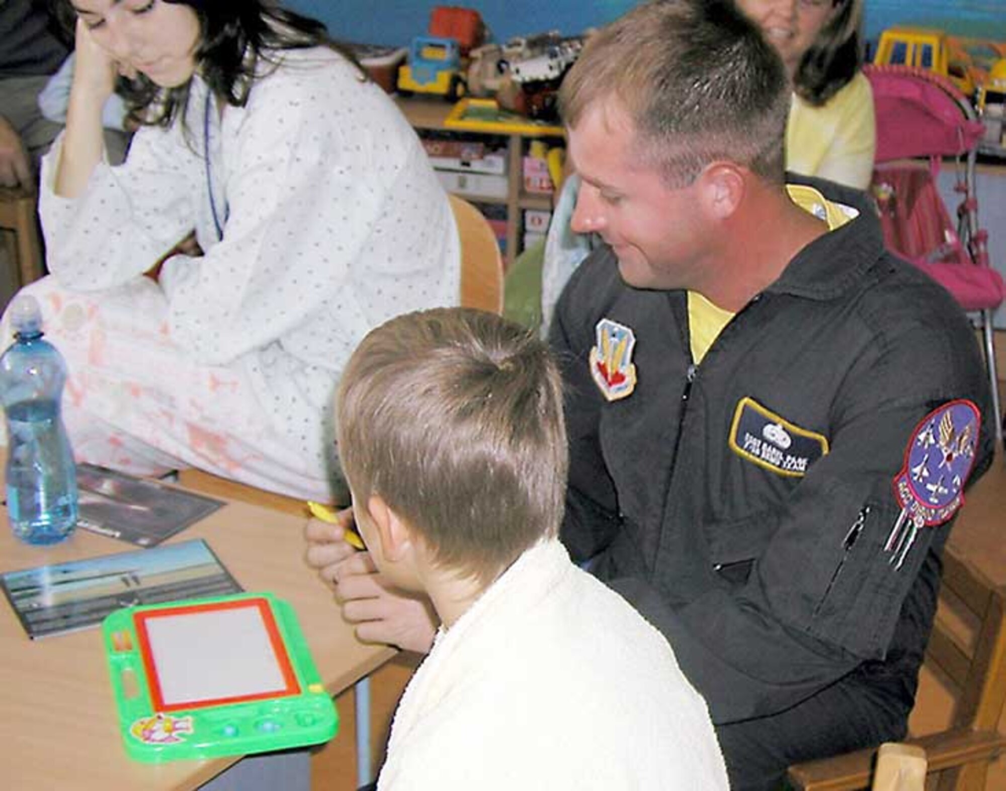 CZECH REPUBLIC-- Staff Sgt. Daniel Wells and other members of the Viper East F-16 Demonstration Team visit sick children in a Czech Republic hospital recently. They were there performing an airshow in country. The Czech Republic is the 20th airshow performance for the demo team this year. They have performed for more than 7 million people this season. (Courtesy photo)