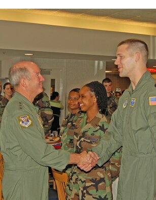 Gen. Duncan McNabb, Air Mobility Command commander, greets Airman 1st Class Michael Irish,  9th Airlift Squadron loadmaster, during the general's luncheon with 436th Airlift Wing Airmen at the Patterson Dining Facility Monday. (U.S. Air Force photo/Staff Sgt. James Wilkinson)