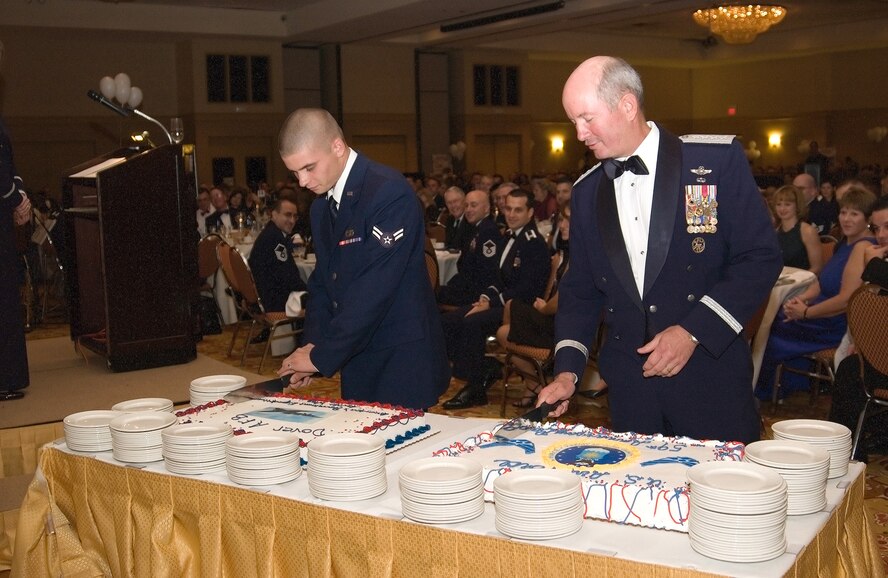 (Left to right) Airman 1st Class James Spoon-Roth, 436th Aerial Port Squadron, and Gen. Duncan McNabb, Air Mobility Command commander, each cut a cake Saturday in celebration of the U.S. Air Force’s 59th anniversary during Dover's Air Force Ball. Traditionally, the oldest Airman and the youngest Airman present are selected for the honor. General McNabb is the AMC commander and began his Air Force career in June 1974, while Airman Spoon-Roth, a ramp services technician assigned to the 436th Aerial Port Squadron, entered the Air Force in January and is 19-years-old. (U.S. Air Force photo/Jennie Hess)