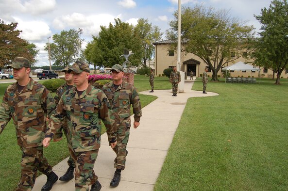 (Front row, left to right) Staff Sergeants Kyle Stryker and Brian Craner and (back row, left to right) Tech. Sergeants Brian Goff and Juan Cabal, 373rd Training Squadron, Detachment 3 instructors, march in formation away from the base flagstaff after standing vigil for 10-minutes and being relieved by the 436th Security Forces' vigil detail. Various Dover Airmen stood watch for 10-minute shifts from Reveille to Retreat to honor and remember prisoners of war and servicemembers missing in action on National POW/MIA Recognition Day Sept. 15. (U.S. Air Force photo/Senior Airman James Bolinger)