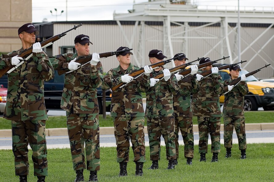 Members of the Dover Air Force Base Honor Guard render a 21-gun salute to commemorate National POW/MIA Recognition Day at the base flag pole here Sept. 15. (U.S. Air Force photo/Roland Balik)
