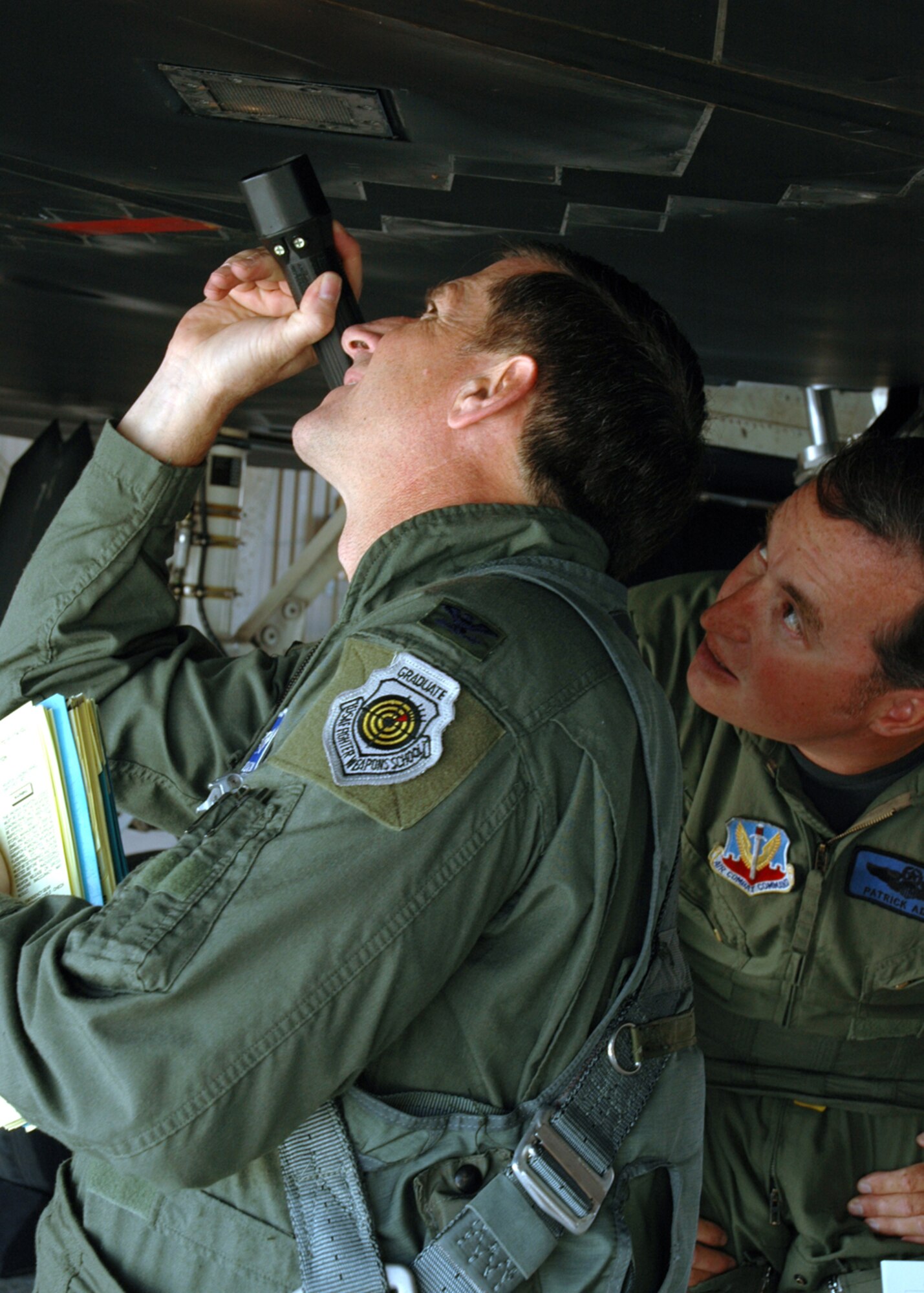 Colonel David Goldfein, Commander, 49th Fighter Wing, and Major Patrick Adams, 7th Fighter Squadron, check the F-117's pass bottle before flight on September 14, 2006, Holloman Air Force Base, New Mexico. The pass bottle is used to start the F- 117's auxiliary power unit. US Air Force photo by Airman Jamal Sutter 