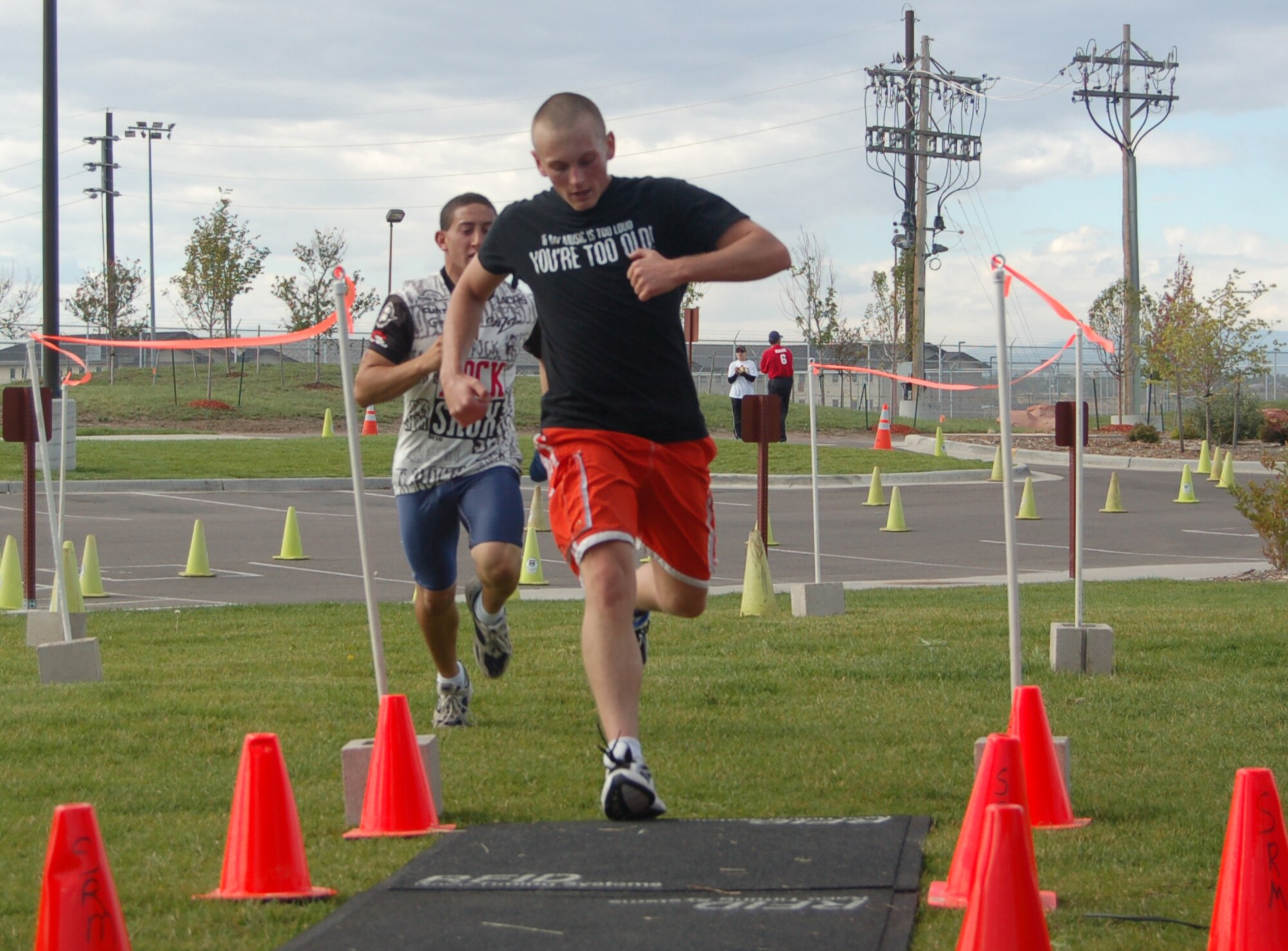 BUCKLEY AIR FORCE BASE, Colo. -- David Kanefsky and Sean Beagle, mini triathlon contestants, cross the finish line in Saturday's event. (U.S. Air Force photo by Senior Airman Jacque Lickteig)